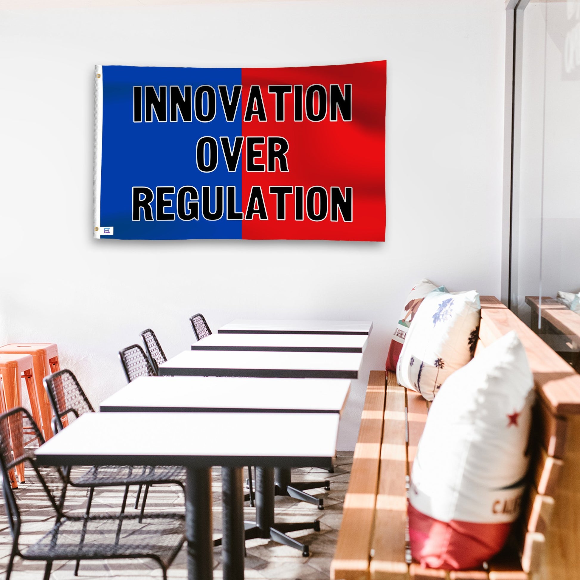 A political flag in royal blue and crimson red with a political statement on a wall in a cafe setting.