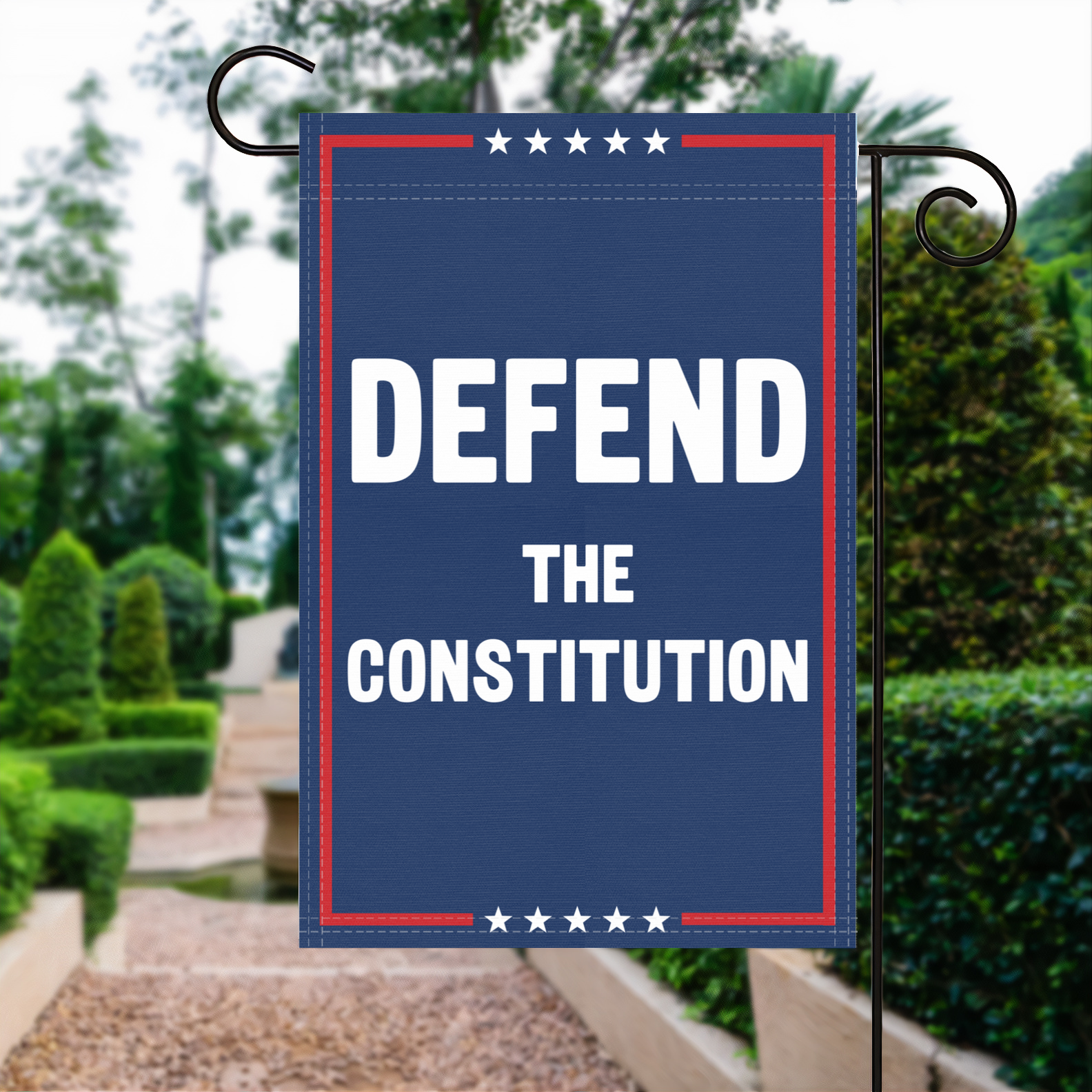 A red, white and blue political garden flag with the slogan Defend The Constitution.