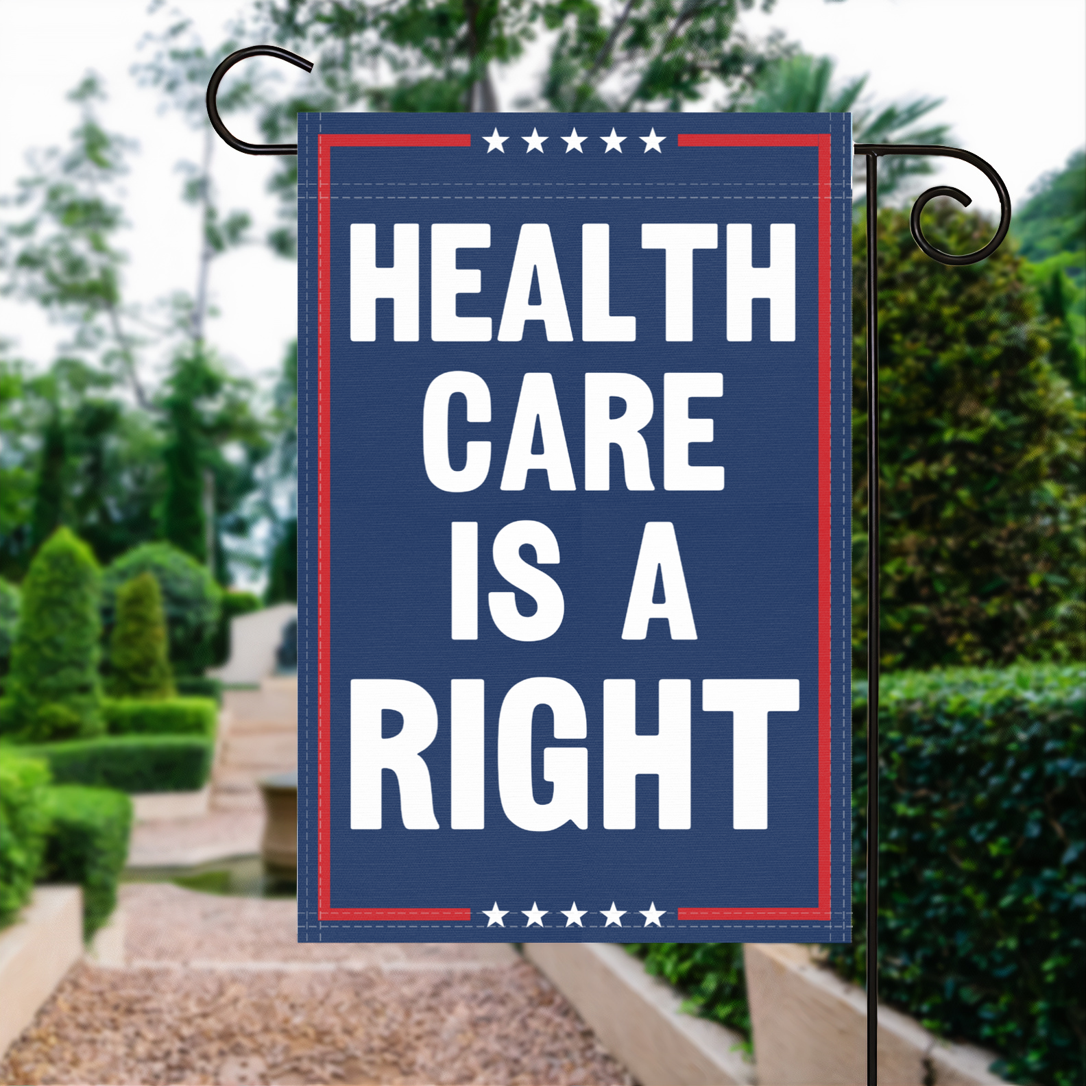 A red, white and blue political garden flag with the slogan Healthcare Is A Right.