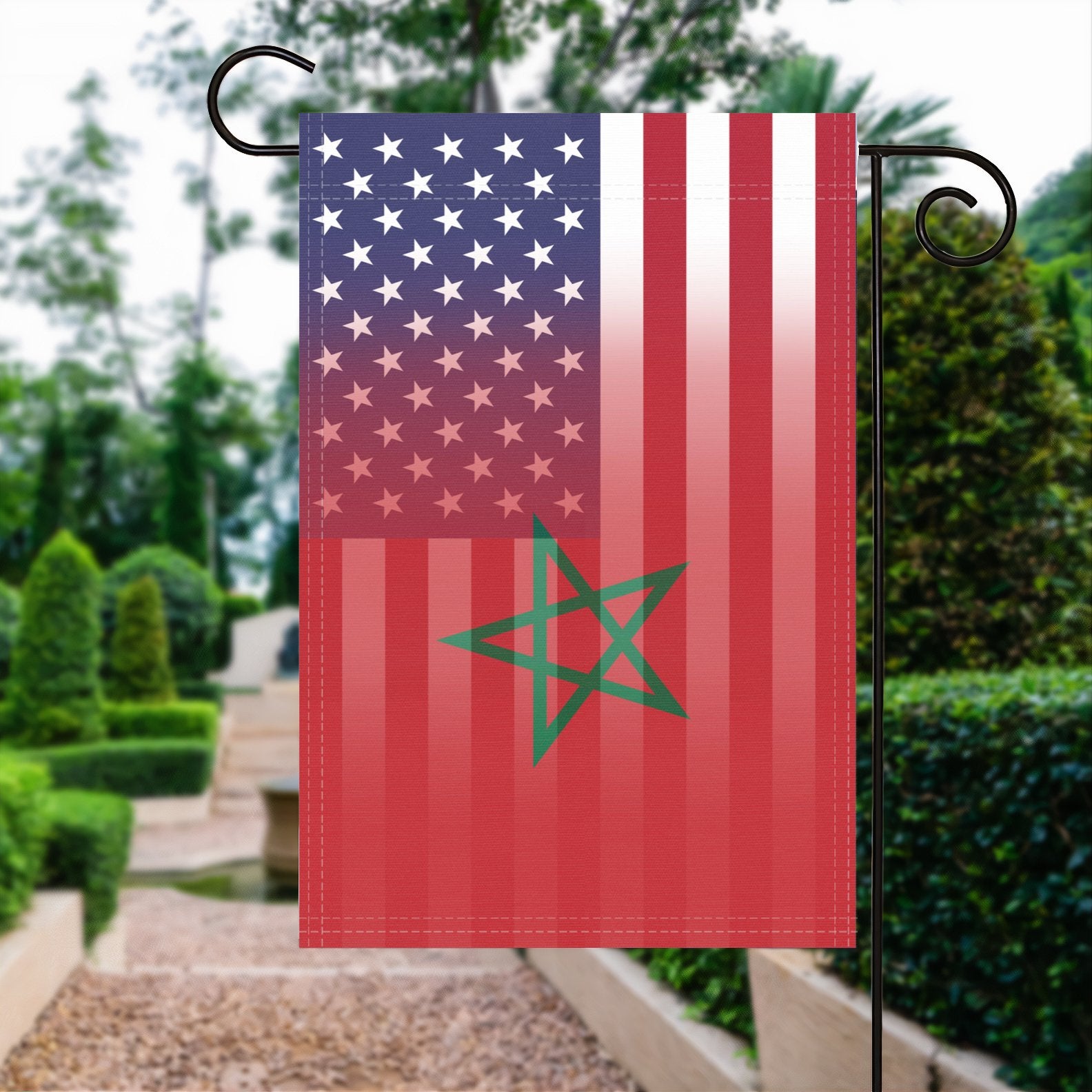 A garden flag with the Moroccan American flag design seamlessly blended with the American flag, displayed in a garden.