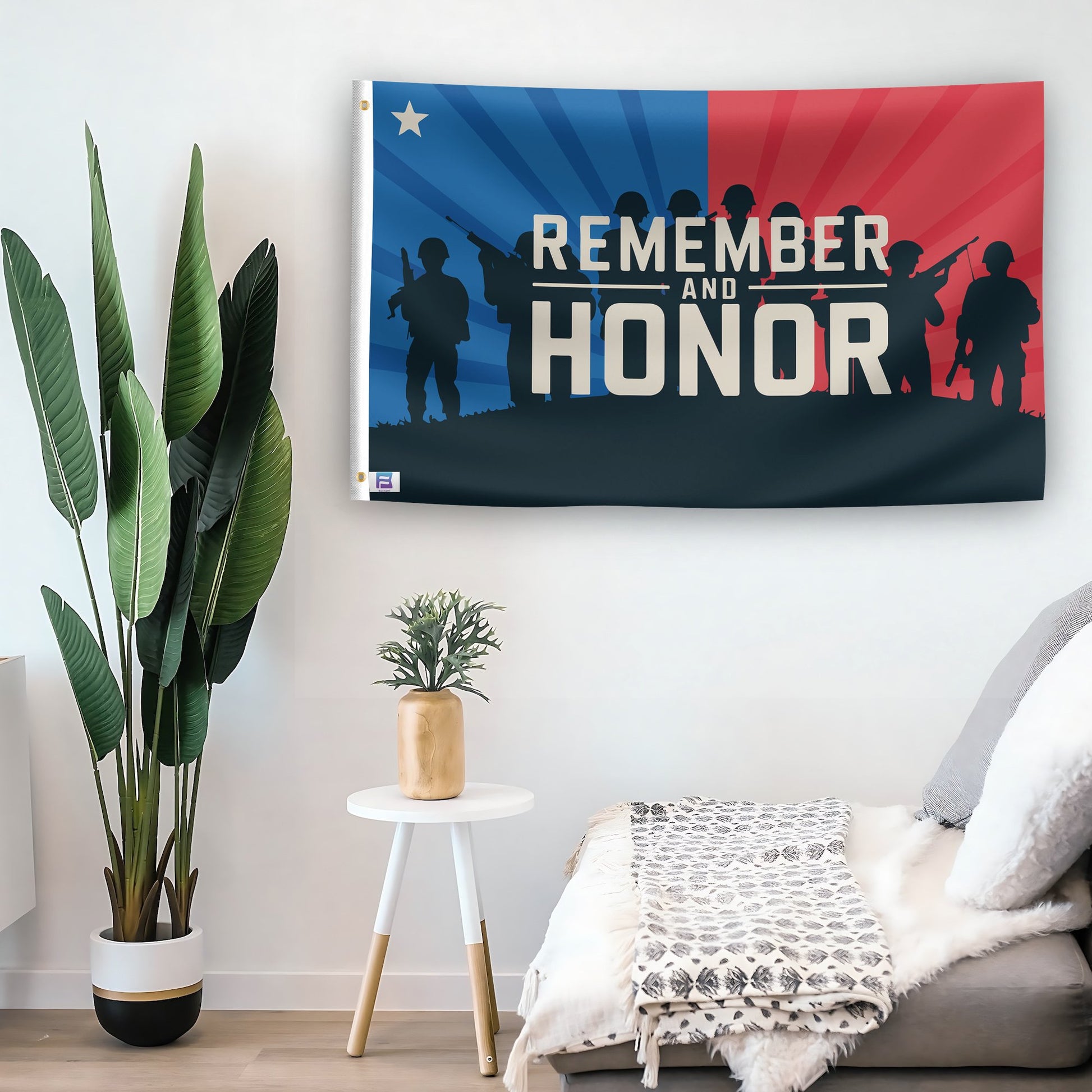 In a home setting, a flag with the saying "Remember And Honor" is mounted on a white wall by a side table.