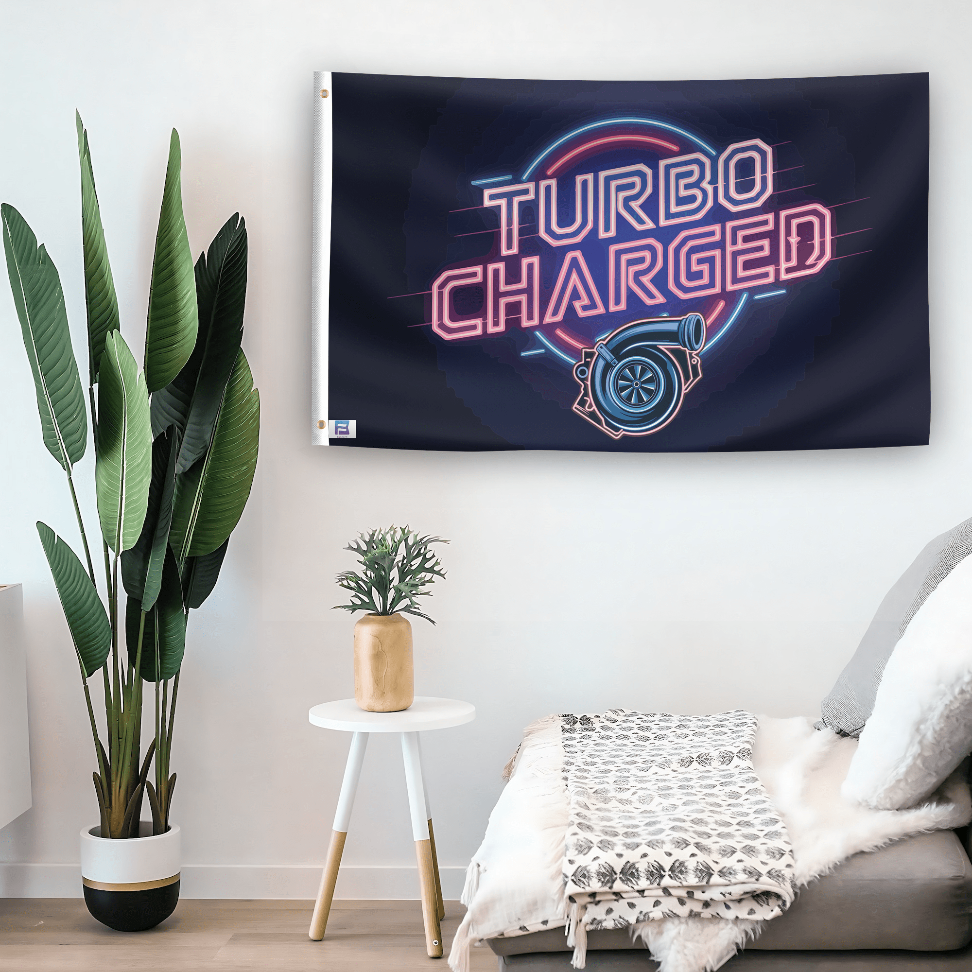 In a home setting, a flag with the saying "Turbo Charged" is mounted on a white wall by a side table.