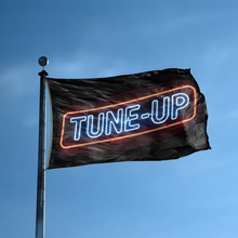 Load image into Gallery viewer, A flag with the saying &quot;Tune Up&quot; displayed on a high pole, with a neon style color scheme.
