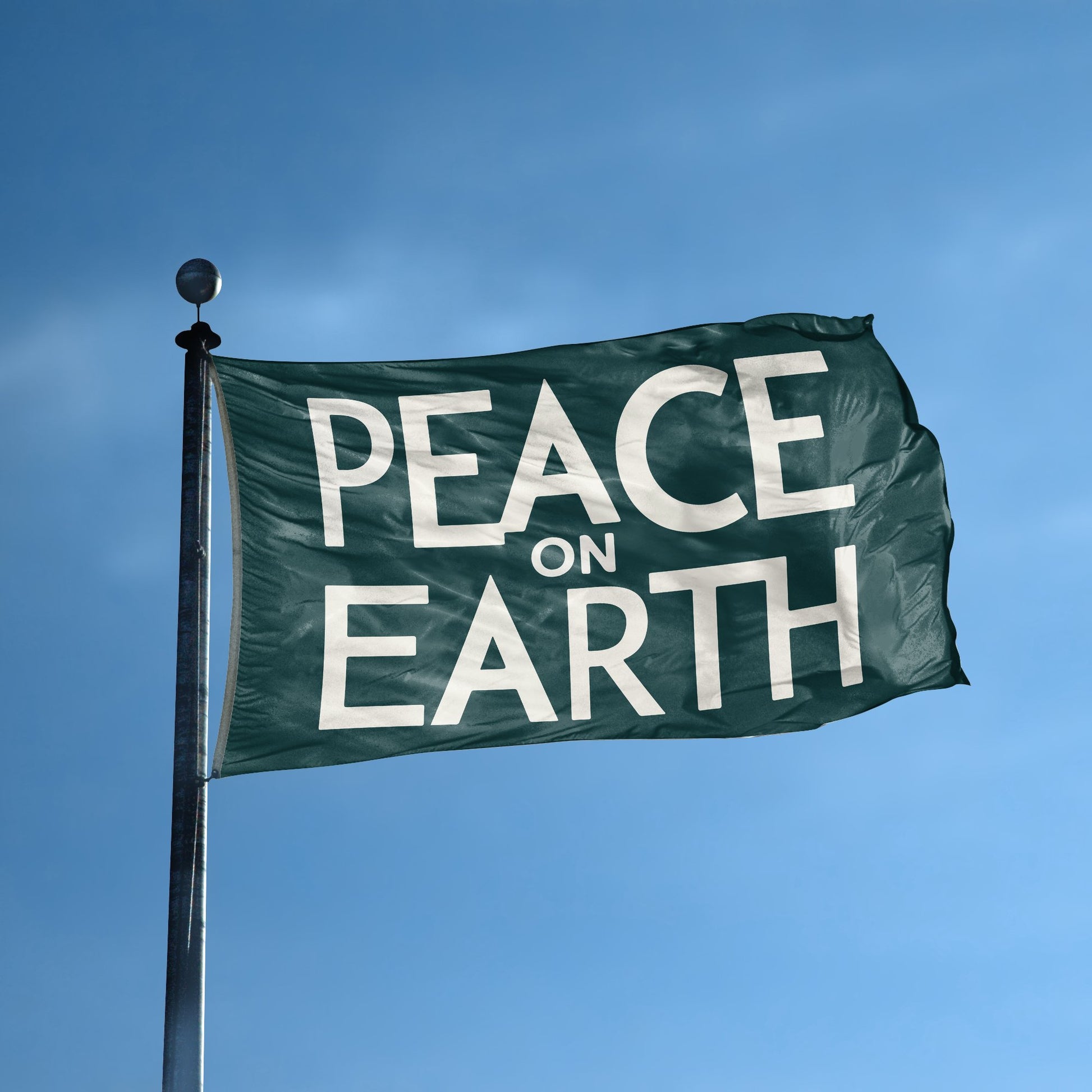 A flag with the saying "Peace On Earth" displayed on a high pole, with a special occasion color scheme.