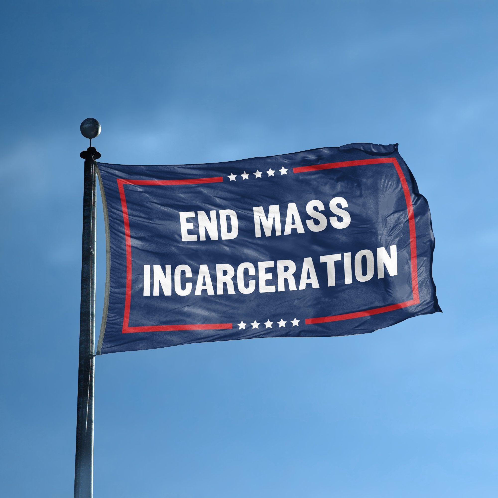 A flag with the saying "End Mass Incarceration Political" displayed on a high pole, with a red, white, and blue color scheme.