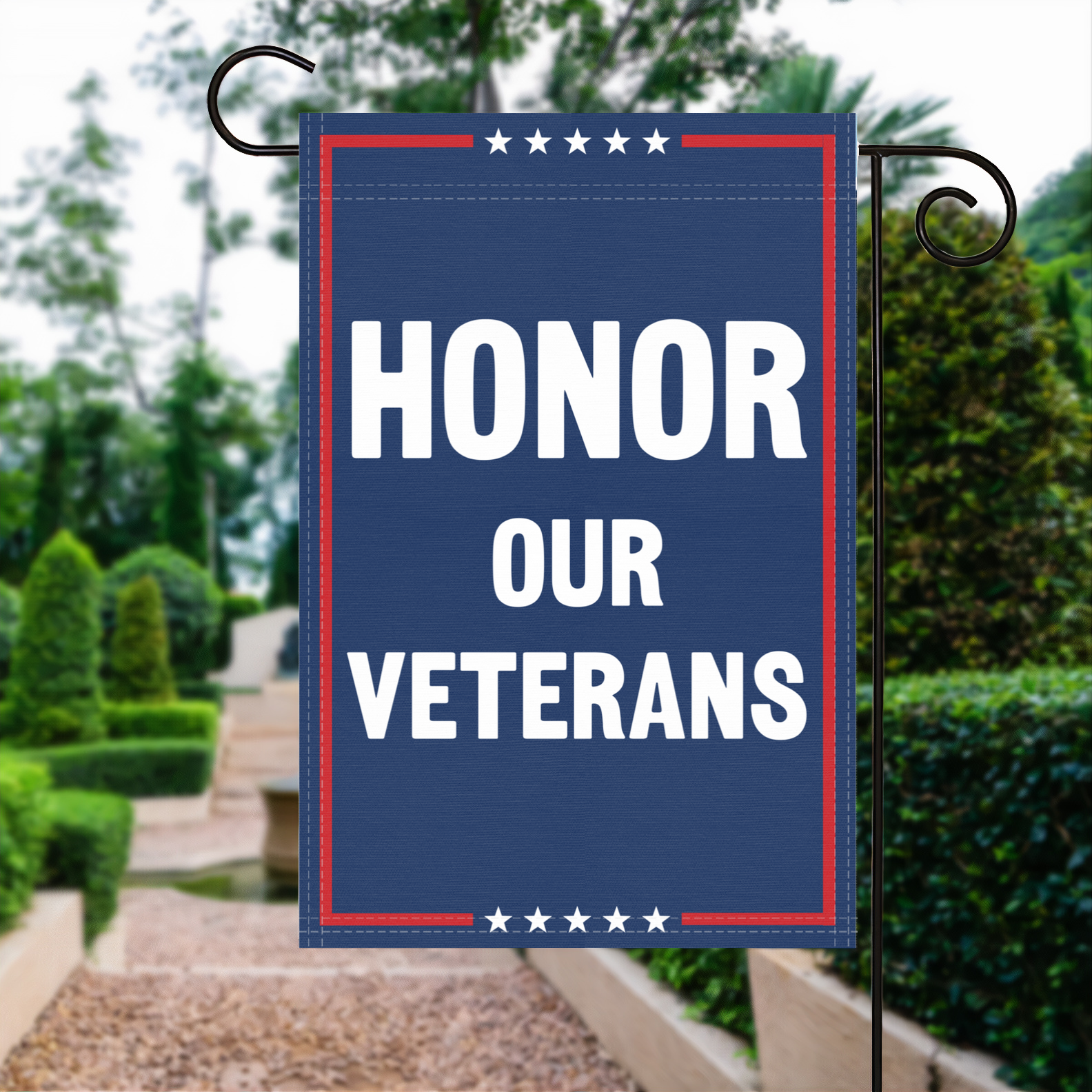 A red, white and blue political garden flag with the slogan Honor Our Veterans.