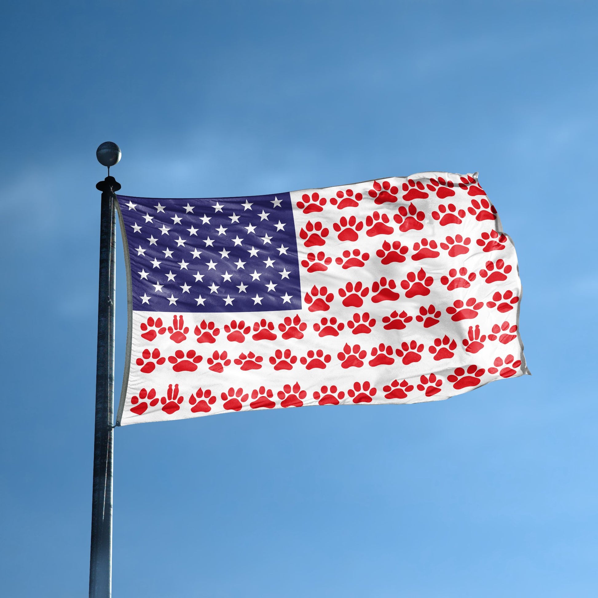 An american flag with the red stripes changed to match the theme "Paw Prints Stripes American" displayed on a high pole.