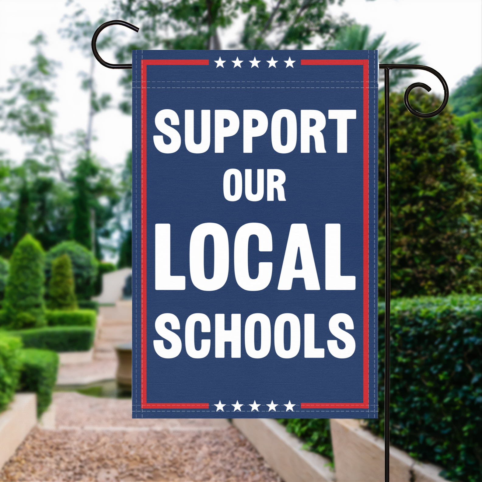 A red, white and blue political garden flag with the slogan Support Our Local Schools.