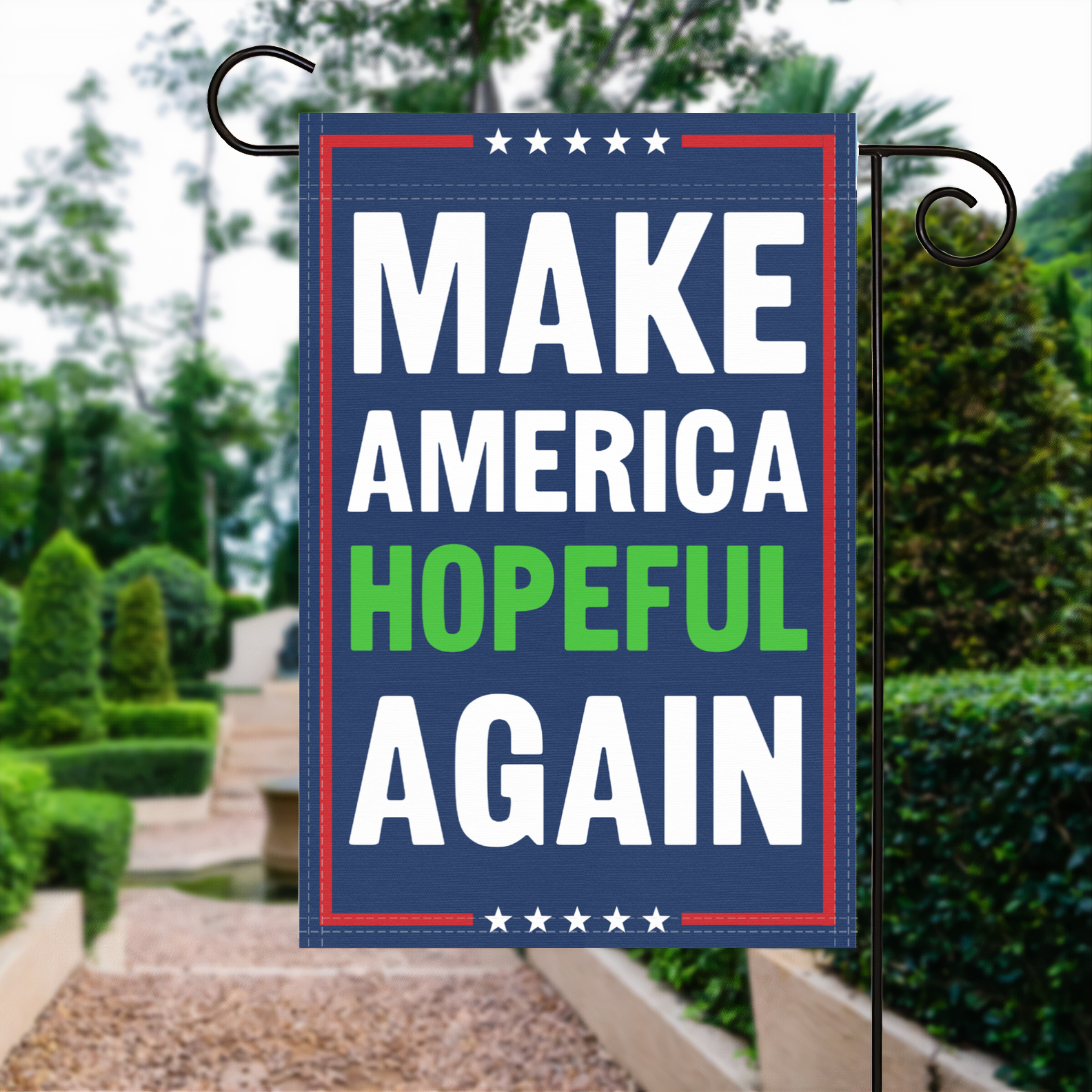 A red, white and blue political garden flag with the slogan Make America Hopeful Again.