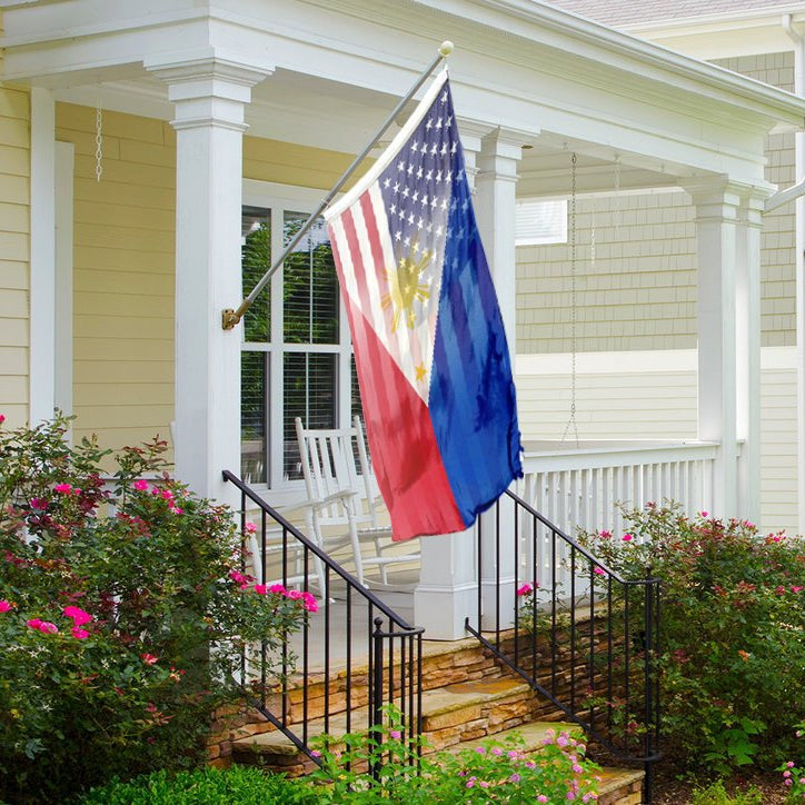 A hybrid flag on a front porch featuring elements of the American and Filipino flags, with a predominantly red and blue color scheme and a sun motif.