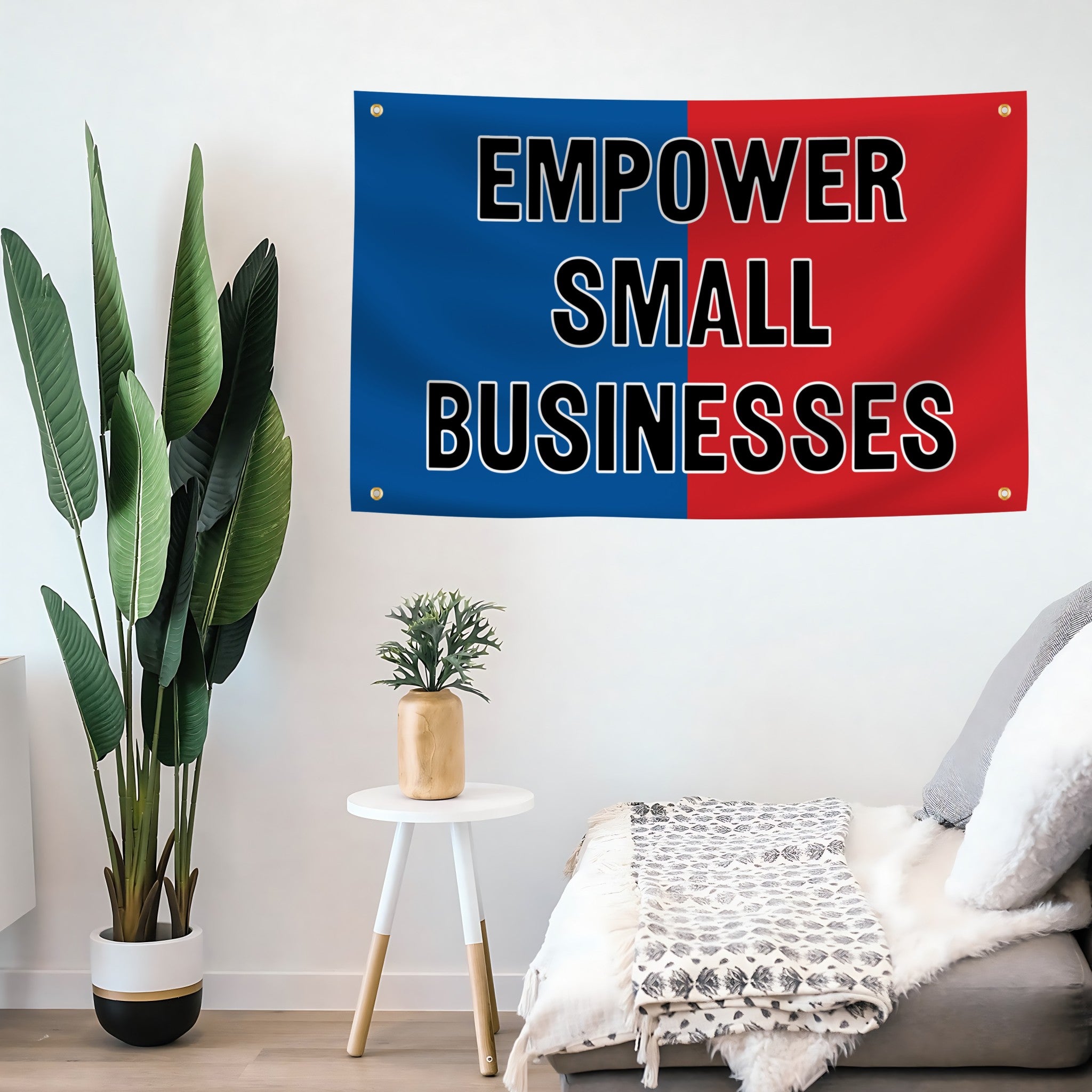 A banner with "Empower Small Businesses" with 4 grommets, featuring a patriotic red and blue background mounted on a wall.
