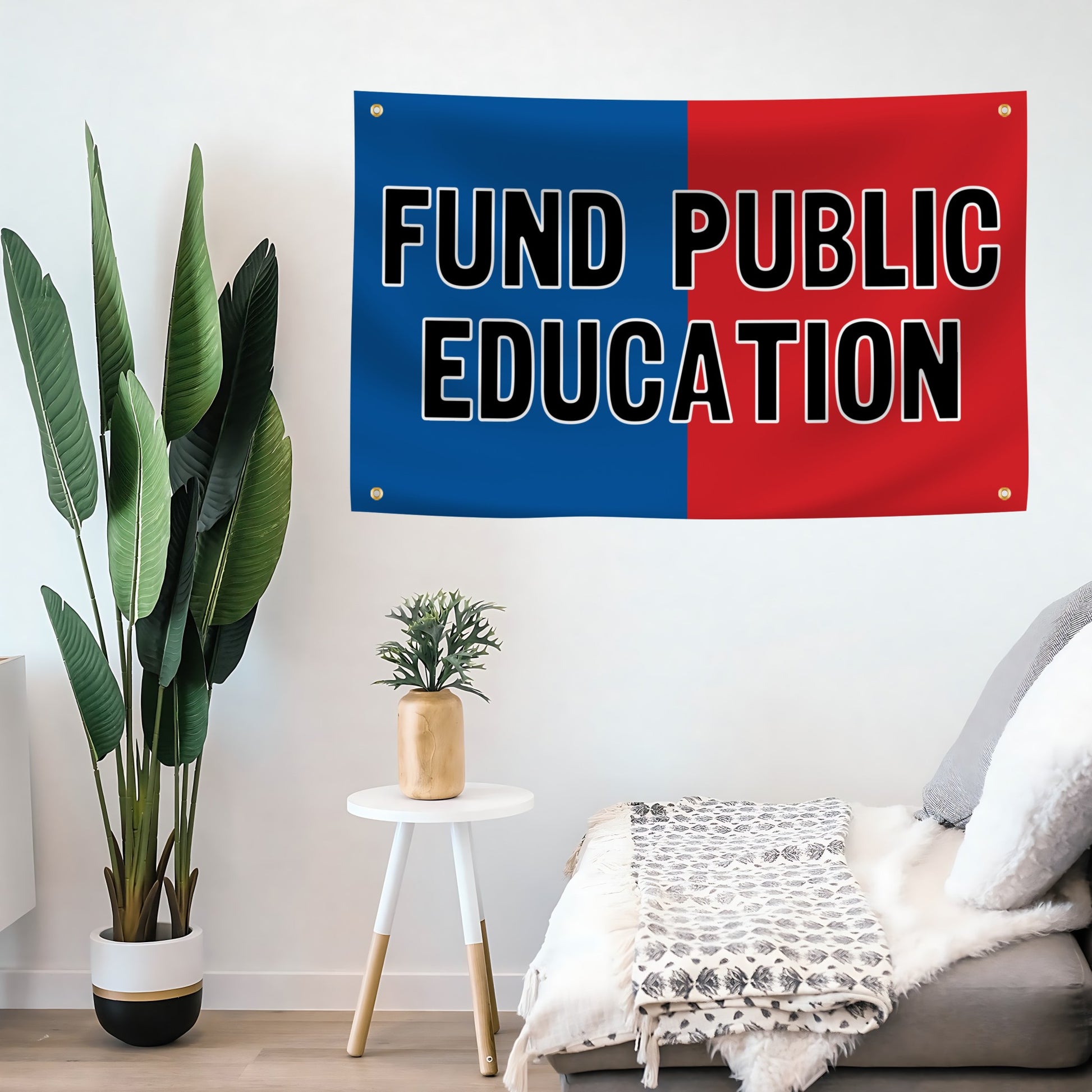 A flag banner with a red and blue design, featuring the text 'FUND PUBLIC EDUCATION' in bold letters mounted on a wall.