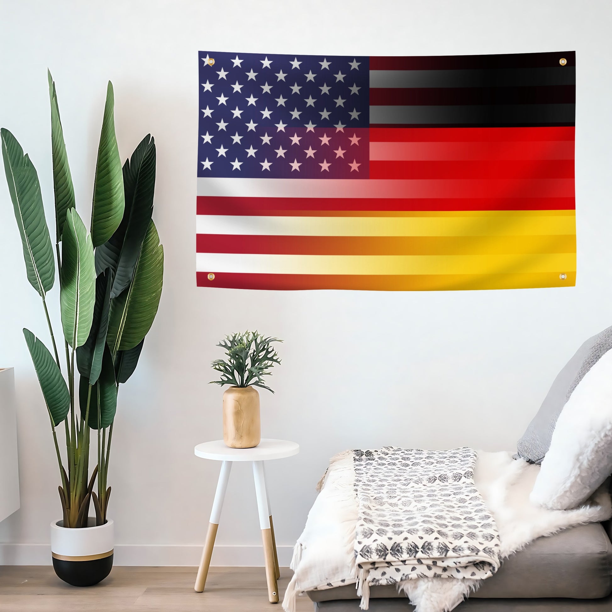 Living room with a large flag of the United States and Germany on the wall, next to a plant and small table.