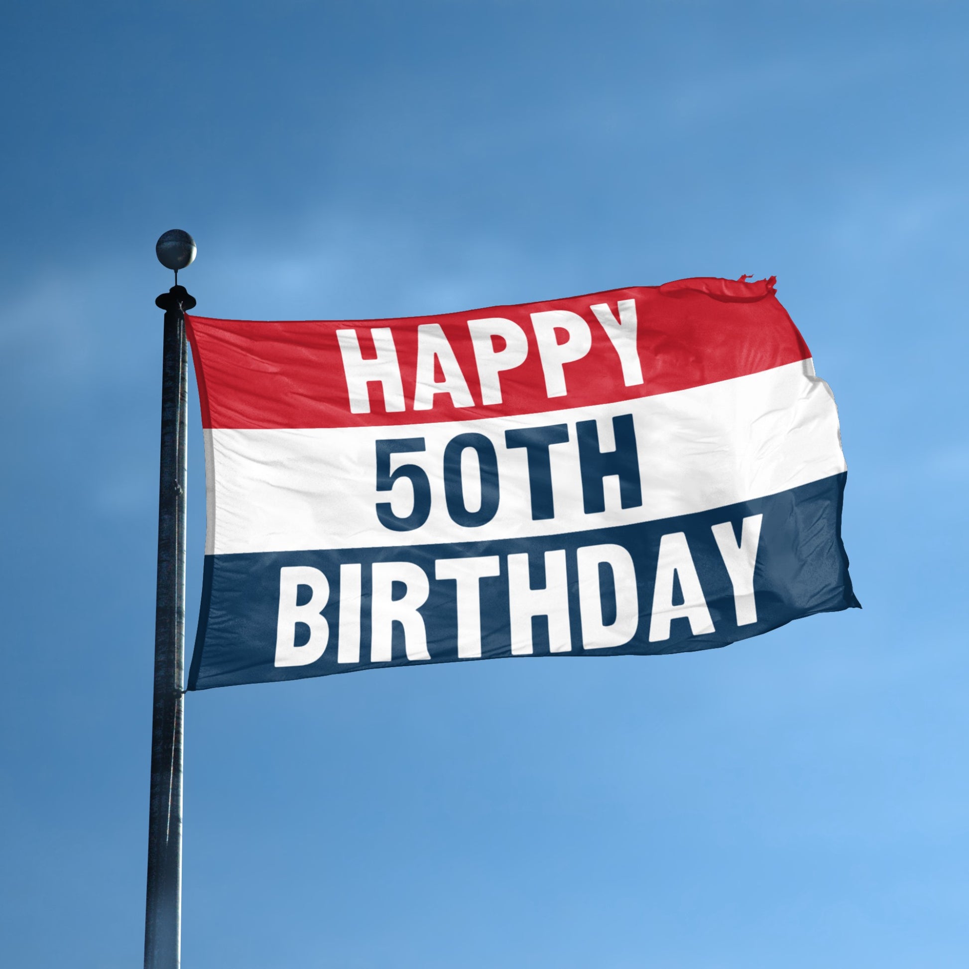 Flag with 'Happy 50th Birthday' text against a blue sky