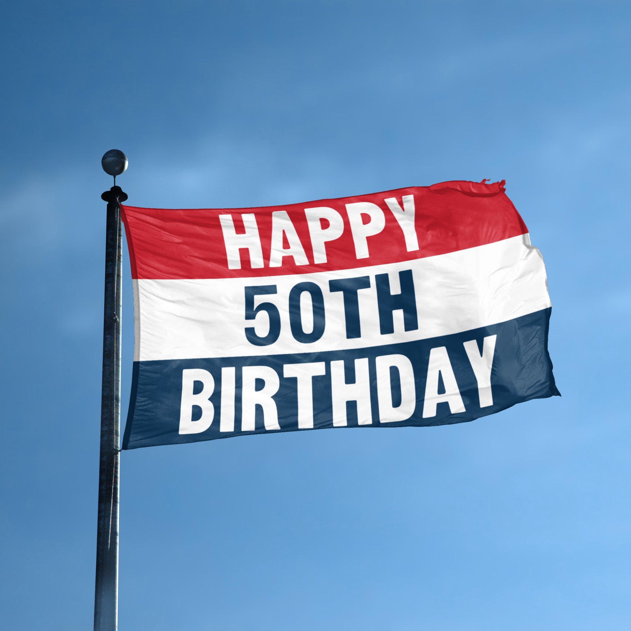 Flag with 'Happy 50th Birthday' text against a blue sky