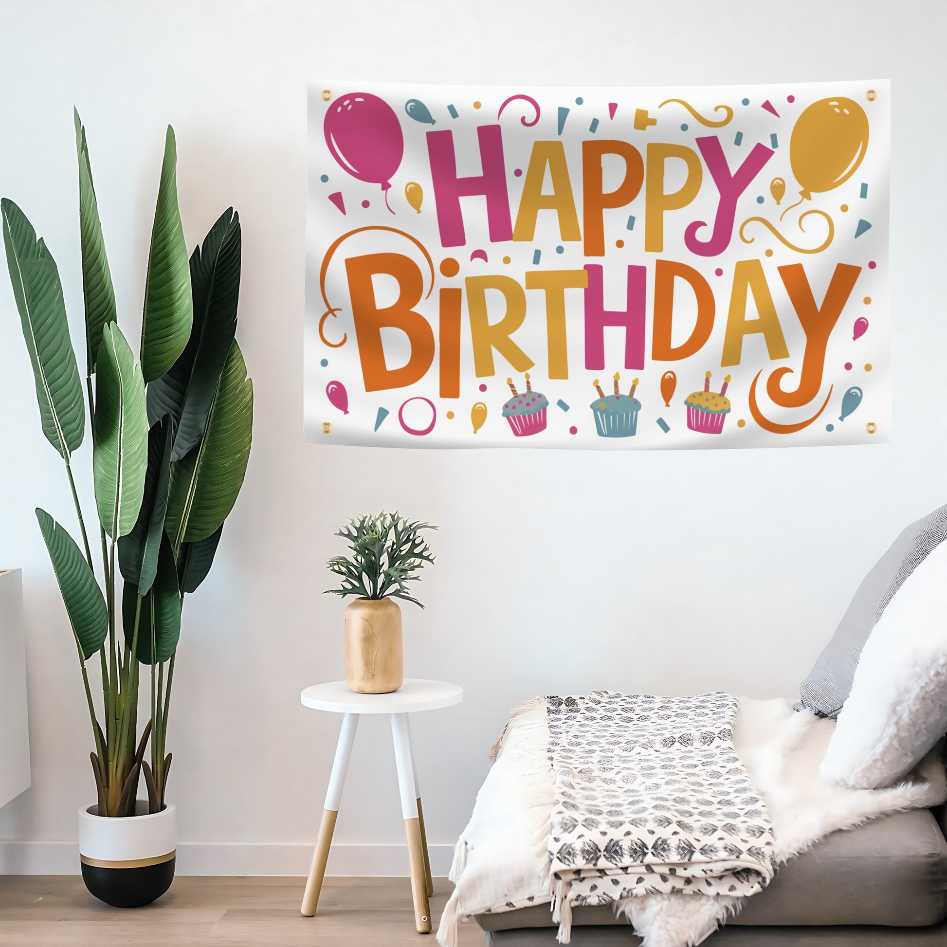 A festive Happy Birthday banner with colorful text hanging on a living room wall. 