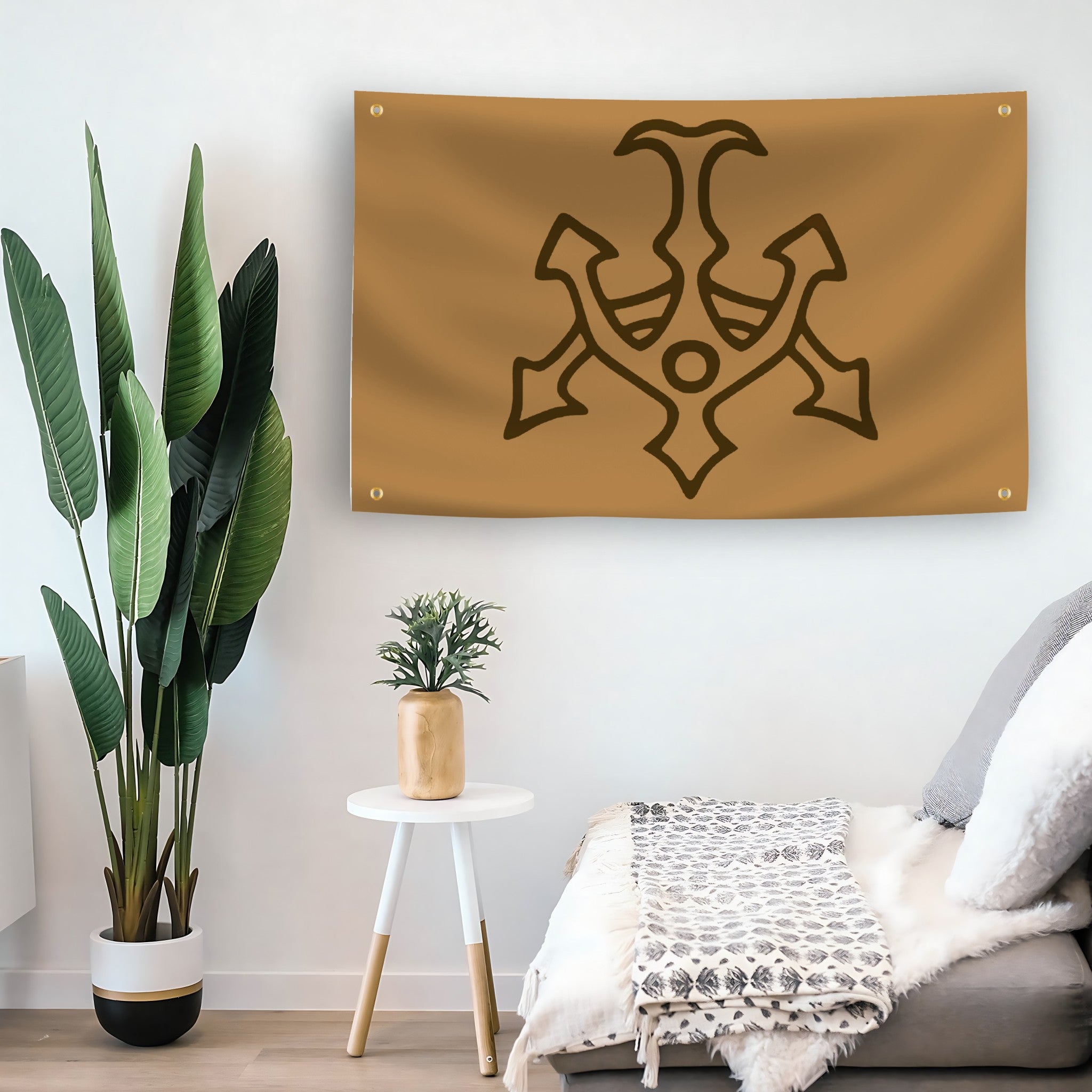 A flag hanging in a living room with a brown background featuring a black silhouette of the Hutt Clan symbol from Star Wars
