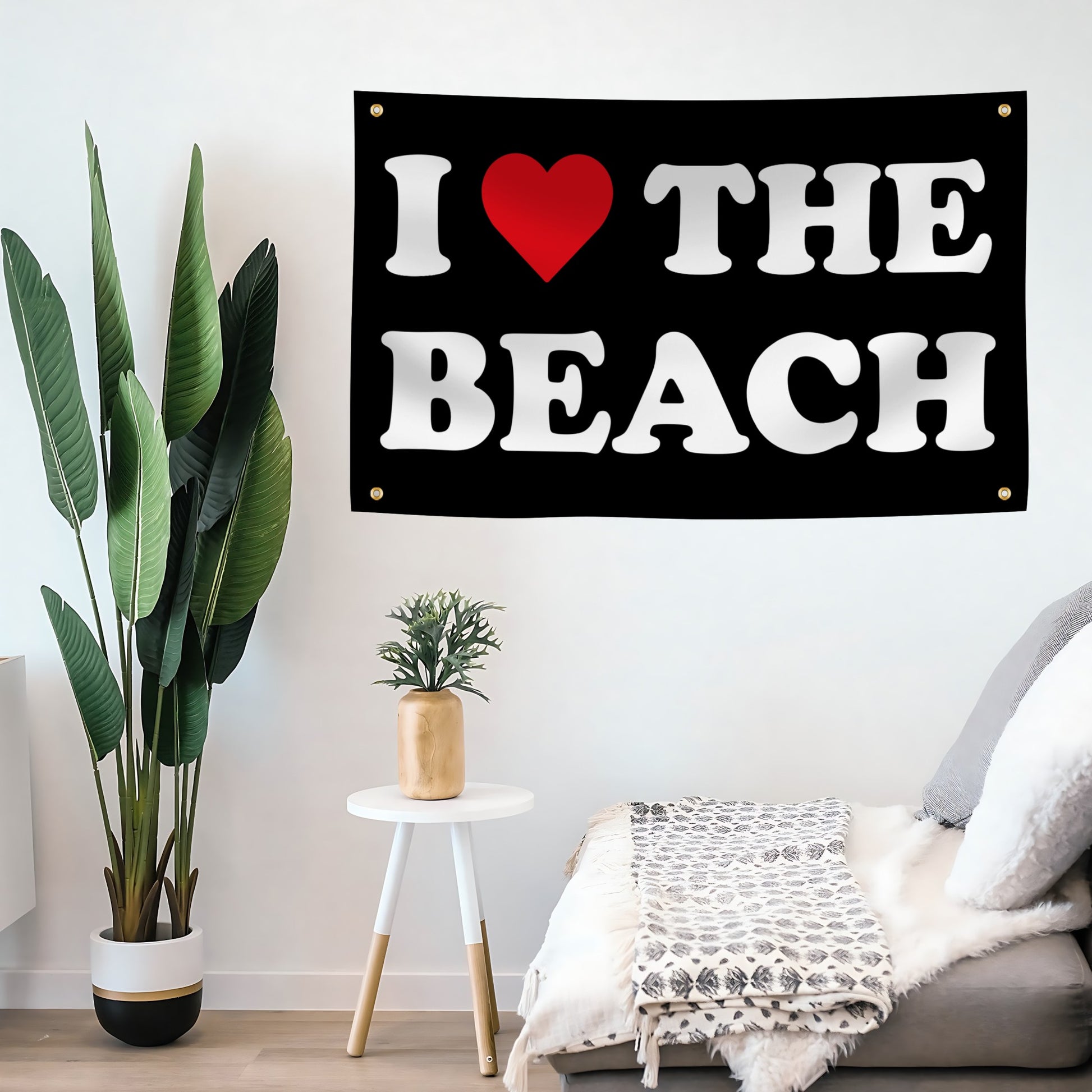 Decorative banner with 'I ❤️ THE BEACH' on a wall in a living room.