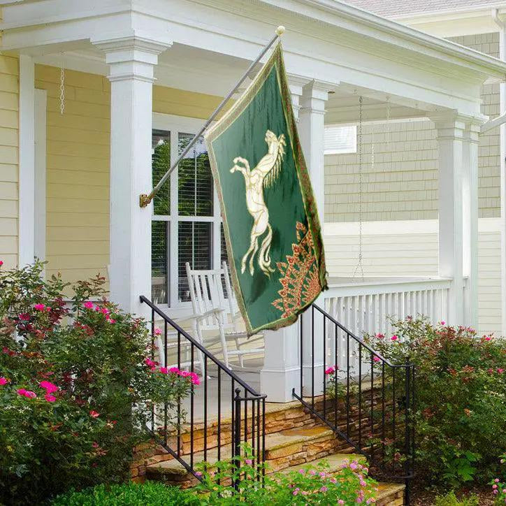 House flag LOTR Rohan Horse Flag by Bannerfi, green with white rearing horse, hanging on a porch.