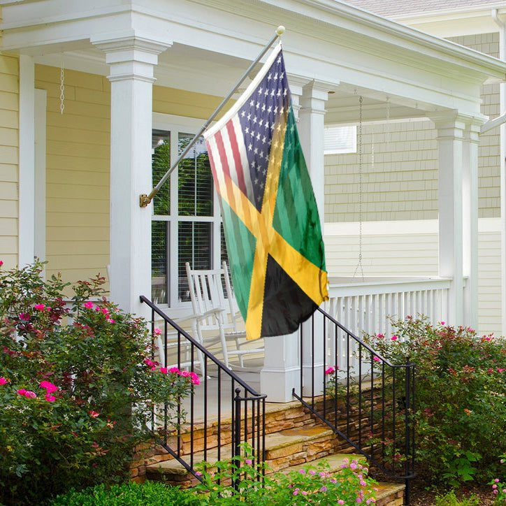 A hybrid flag combining elements of the Jamaican and American flags hanging on a porch flag pole.