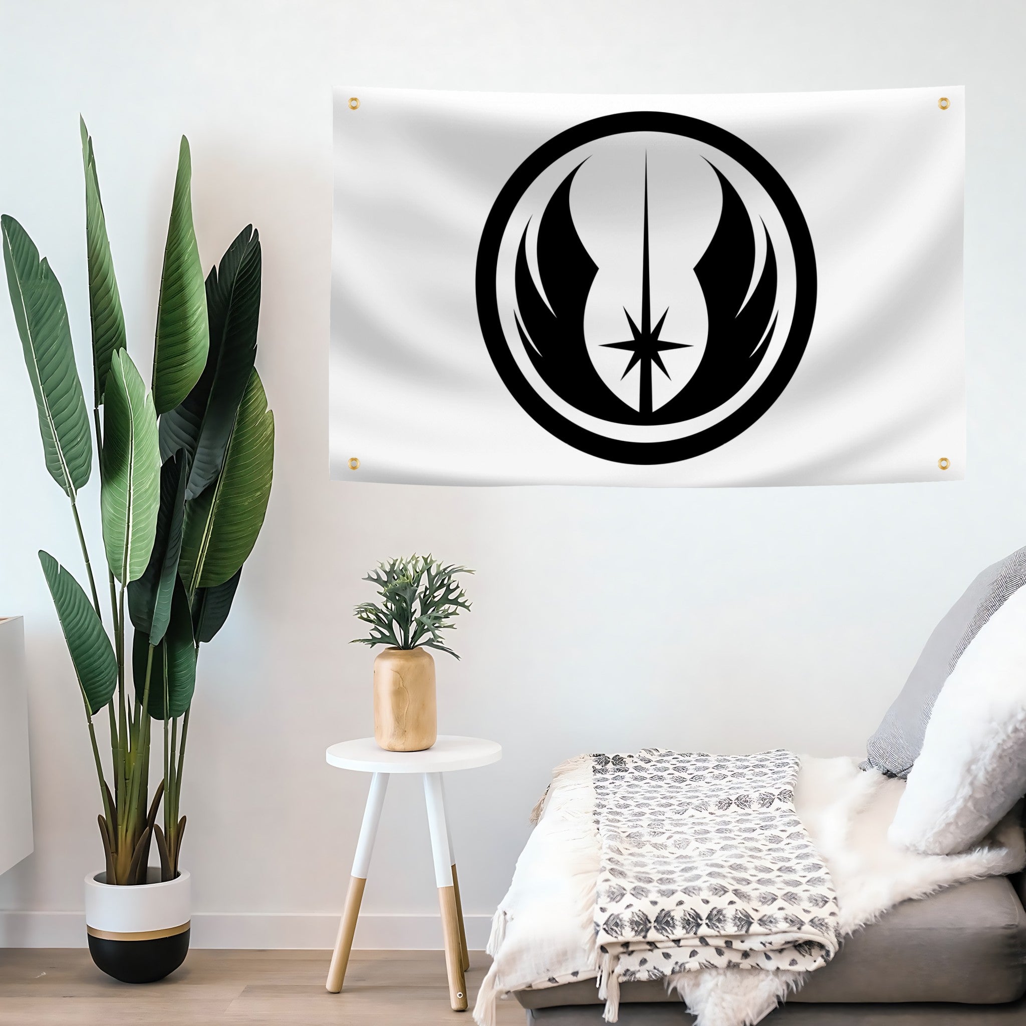 White wall banner with a black jedi order symbol hanging above a sofa in a living room.
