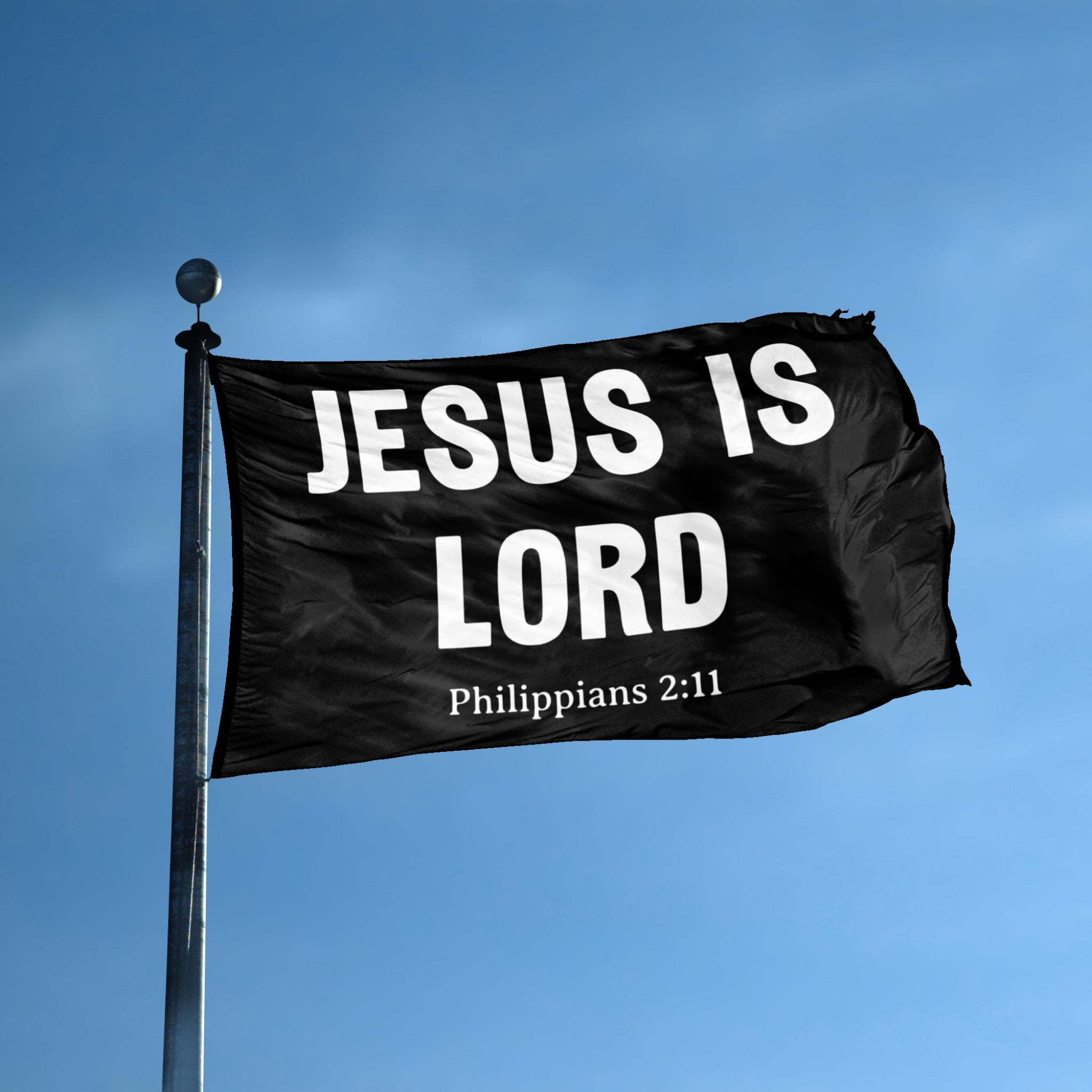 A flag with the theme "Jesus Is Lord Philippians 2:11" displayed on a tall flag pole and blue skies.