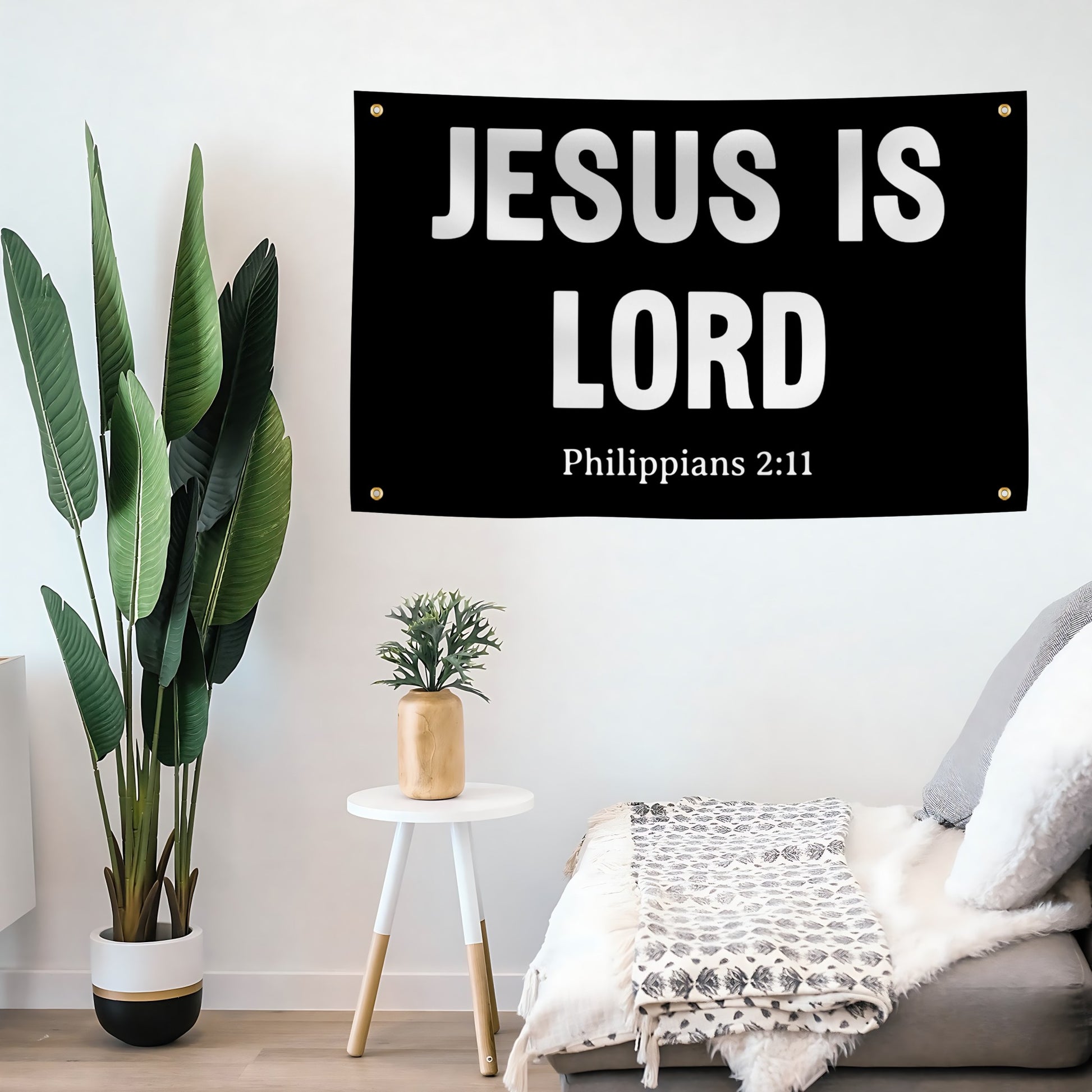 A banner with "Jesus Is Lord Philippians 2:11" displayed on a living room wall.