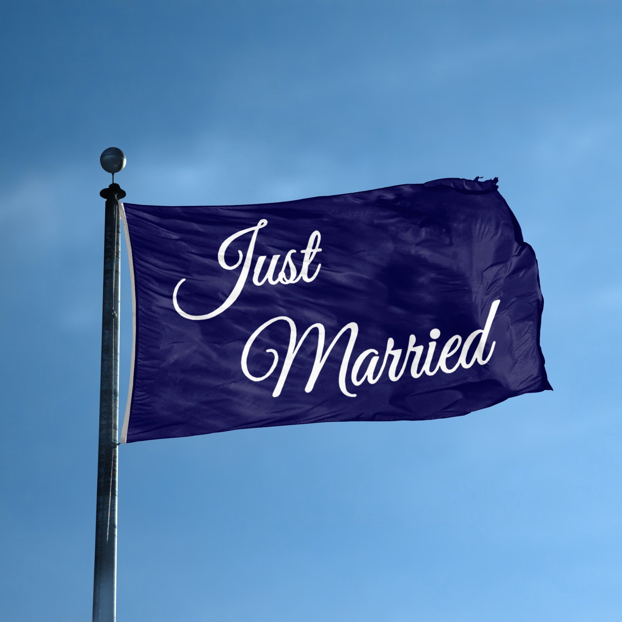 Navy blue flag with 'Just Married' text against a clear blue sky