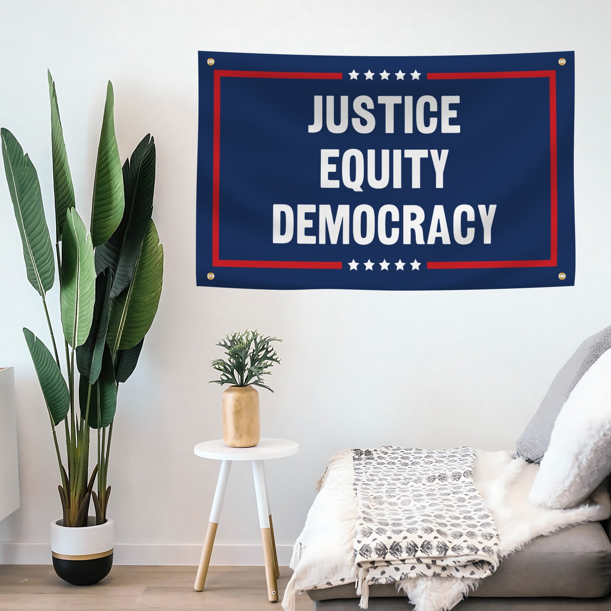 Living room with a 'Justice Equity Democracy' flag banner on the wall, plants, and a sofa.