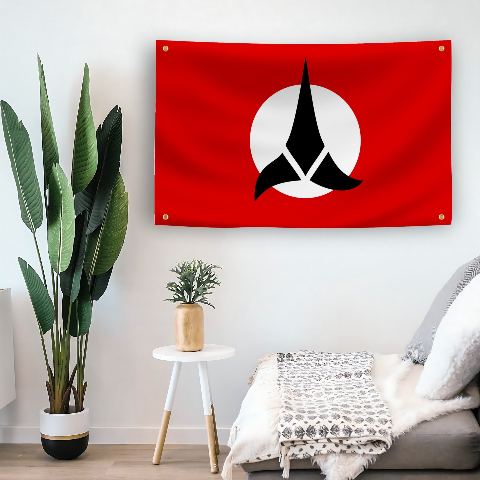 Star Trek Klingon flag with a black and white symbol on a red background hanging on a living room wall