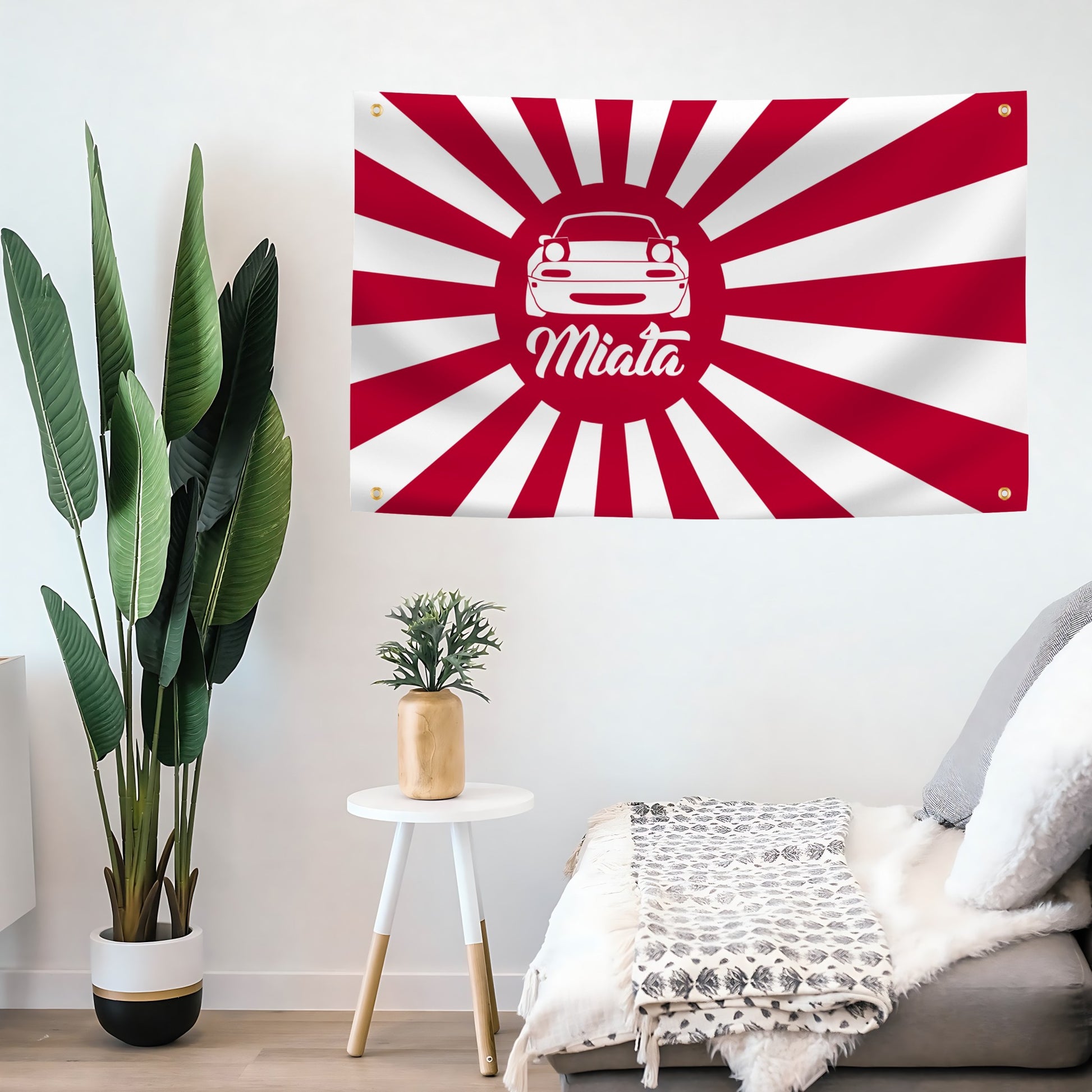 Decorative flag banner with a Miata car design and 'Miata' text on a red and white background, hanging above a living room.