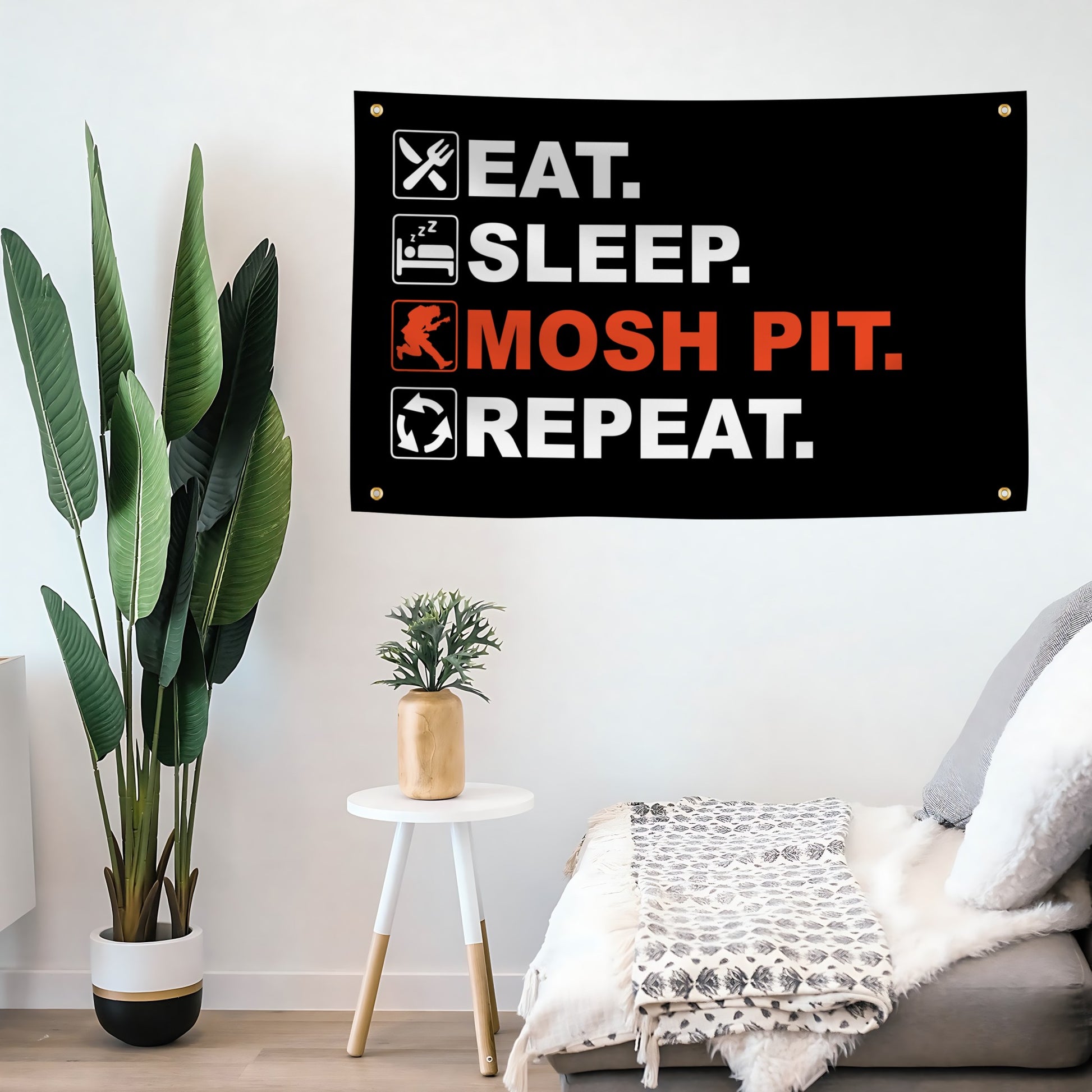 Decorative flag banner with 'Eat. Sleep. Mosh Pit. Repeat.' text in a living room setting.