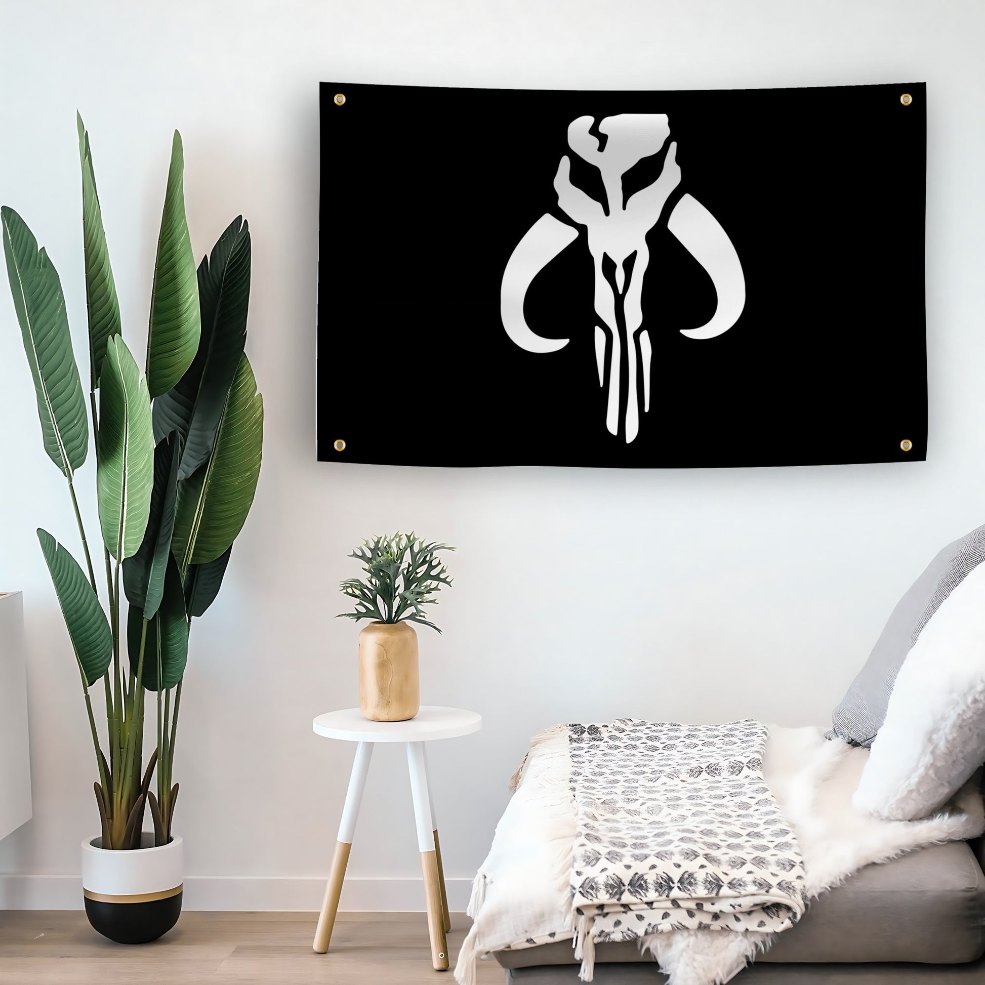 A flag with the Star Wars Mandalorian Mythosaur Skull displayed on a living room wall.