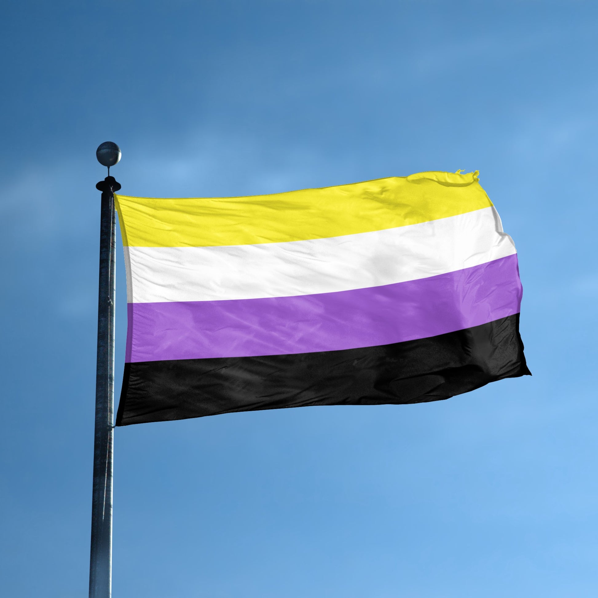Non-binary pride flag waving on a flagpole against a clear blue sky