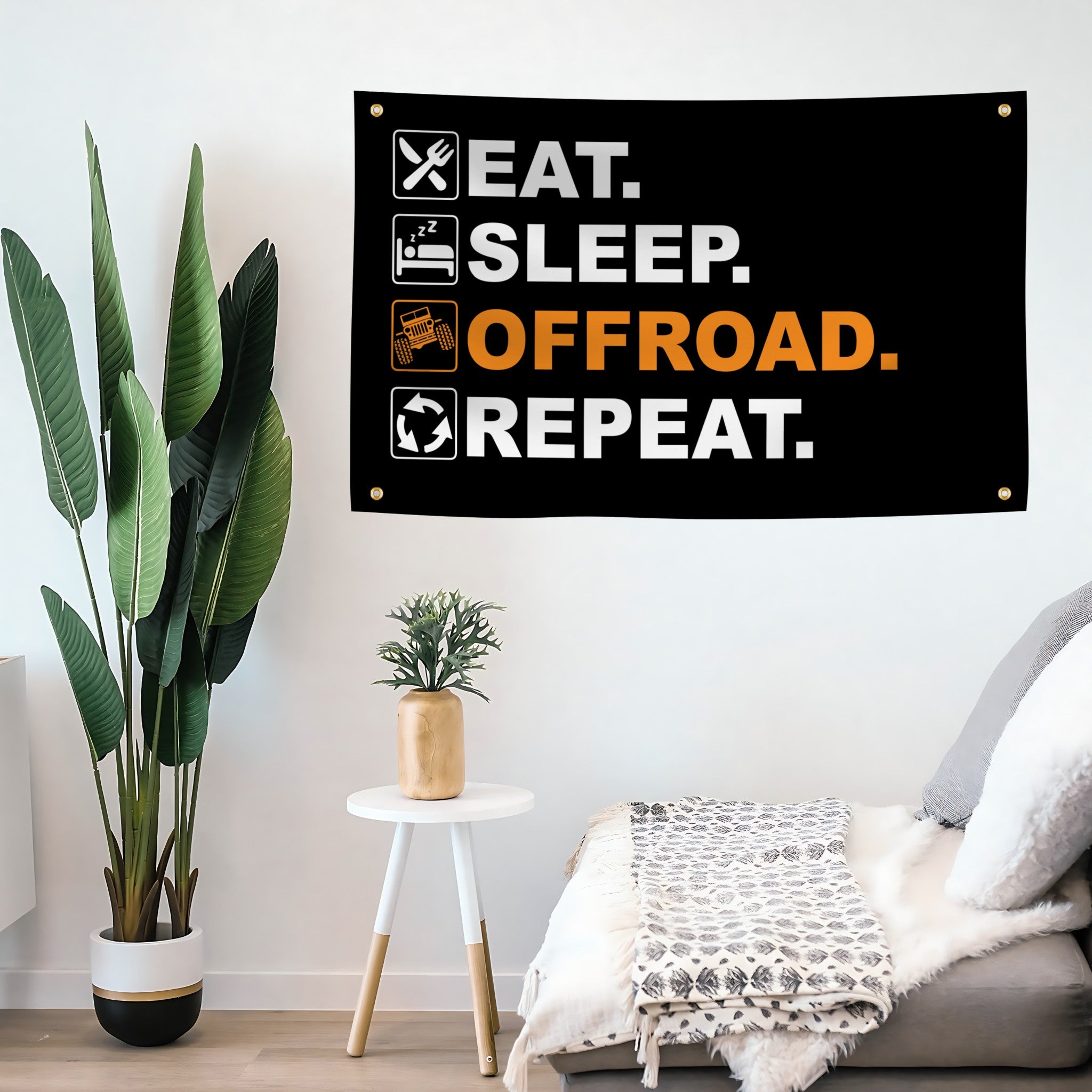 Flag banner with 'Eat. Sleep. Offroad. Repeat.' text in a living room setting.
