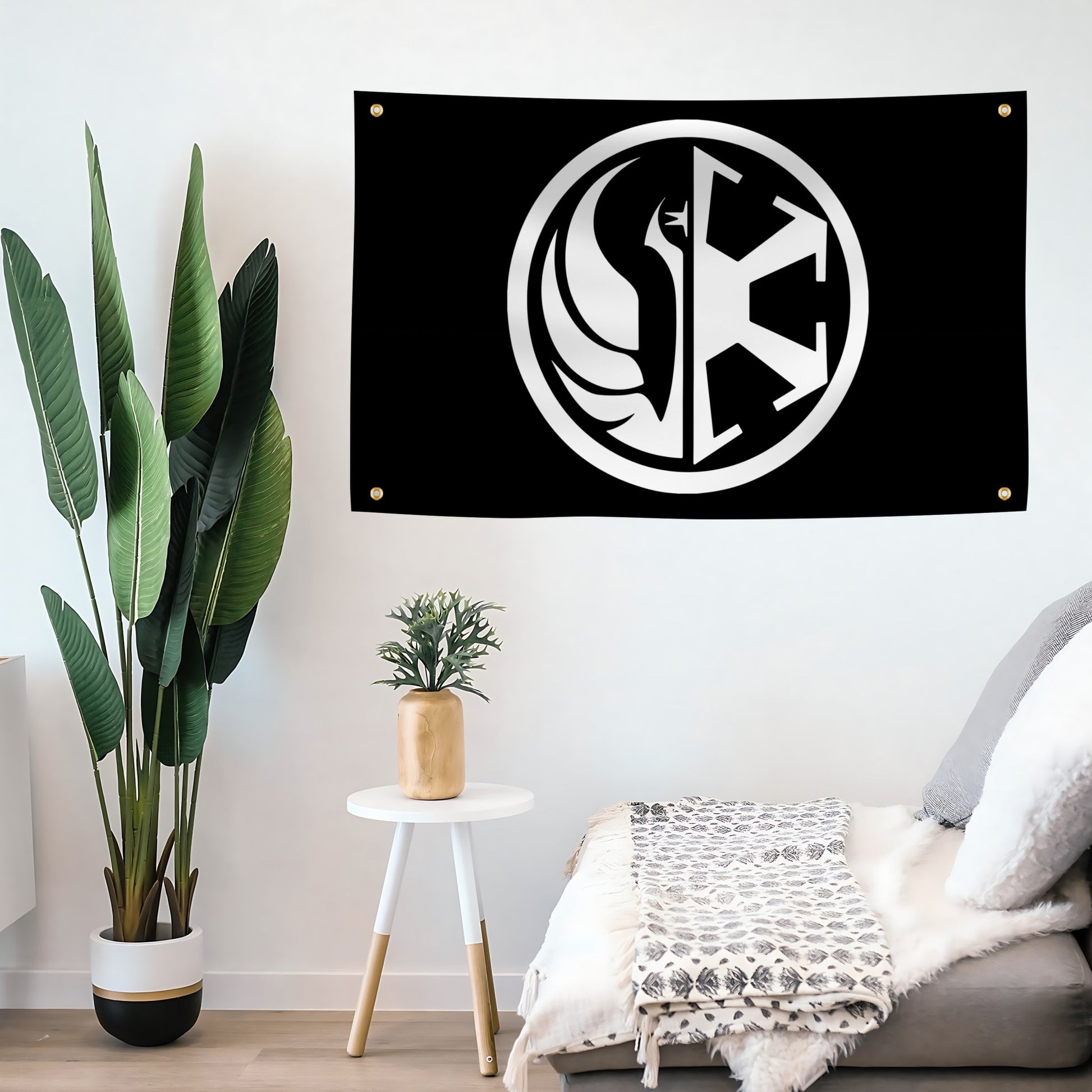 Black flag with a white star wars alliance and empire logo hanging on a wall in a room with plants and furniture.