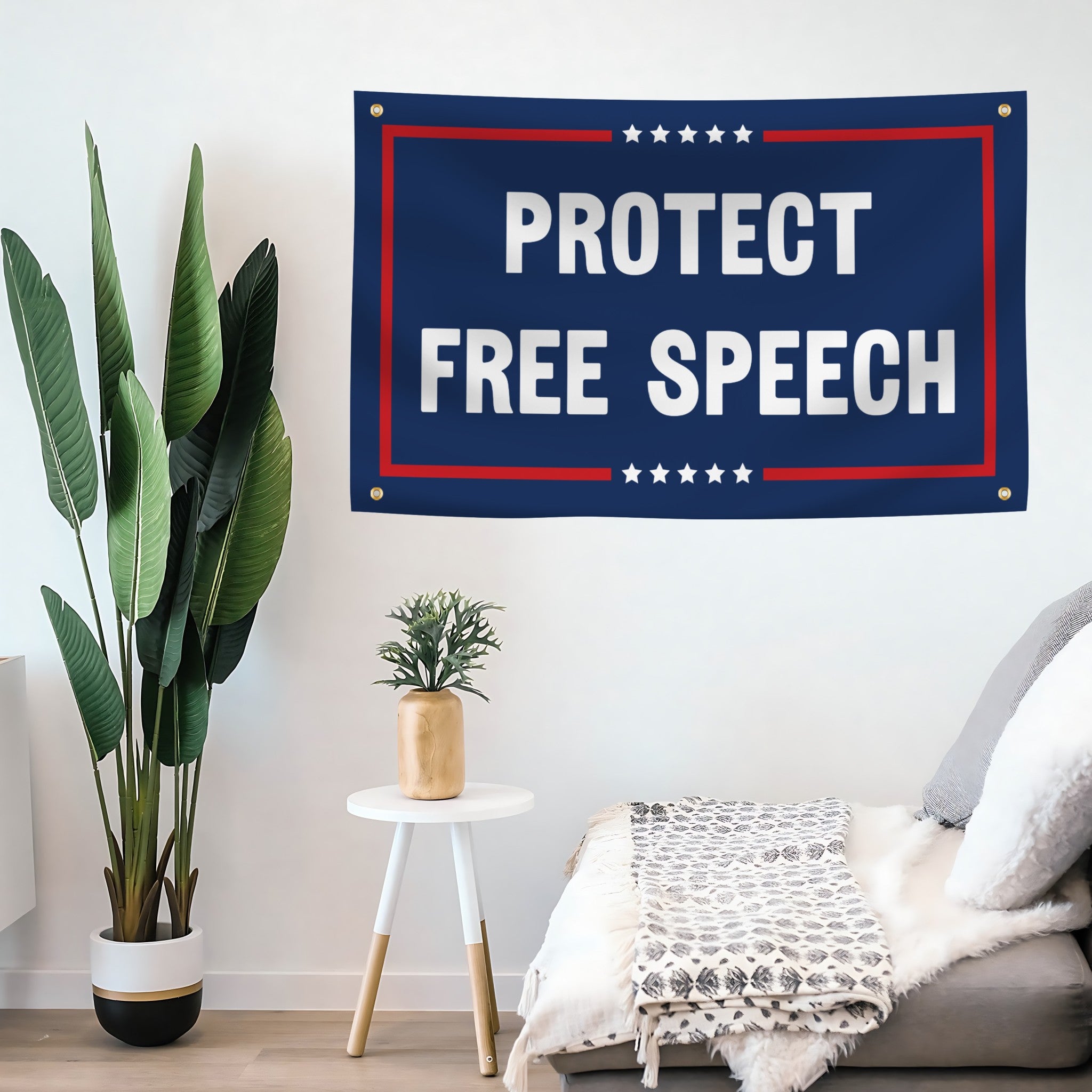 Flag banner with 'Protect Free Speech' text hanging on a wall in a room with plants and furniture.