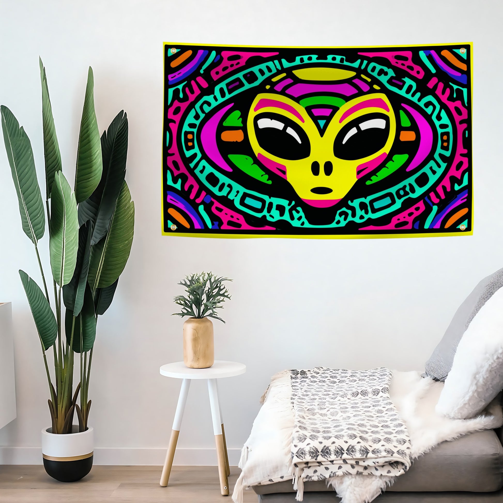 Colorful alien head flag banner on a wall above a sofa with decorative plants.