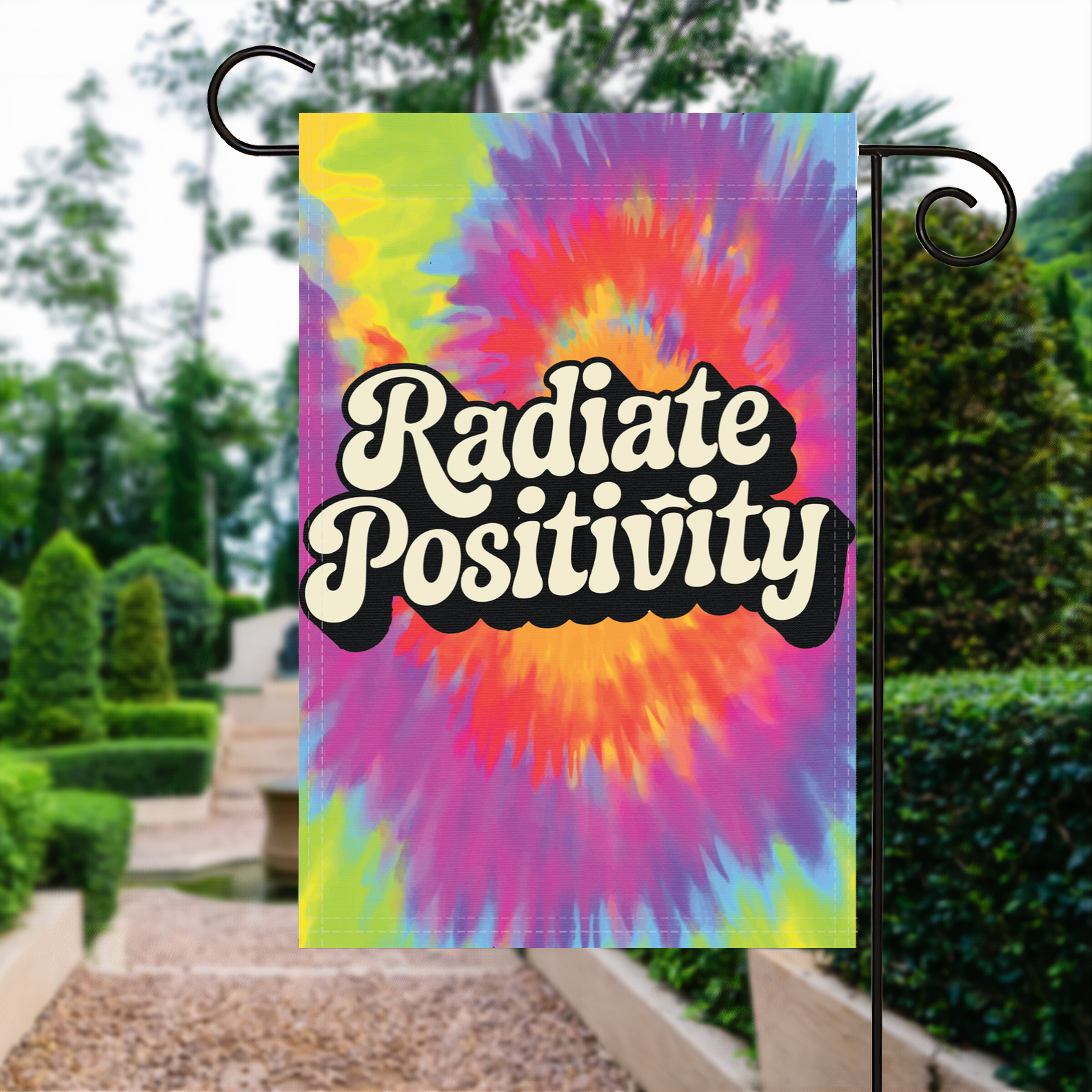 Radiate Postivity garden flag made of weatherproof polyester displayed in a garden | Bannerfi