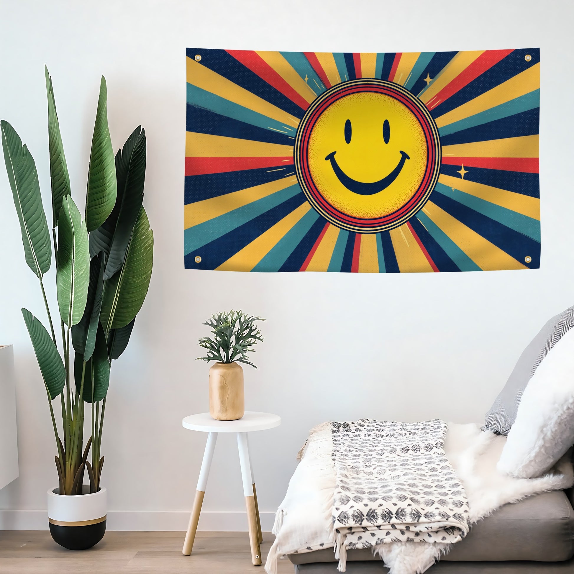 Colorful smiley face flag banner on a wall with a plant and small table in the foreground.