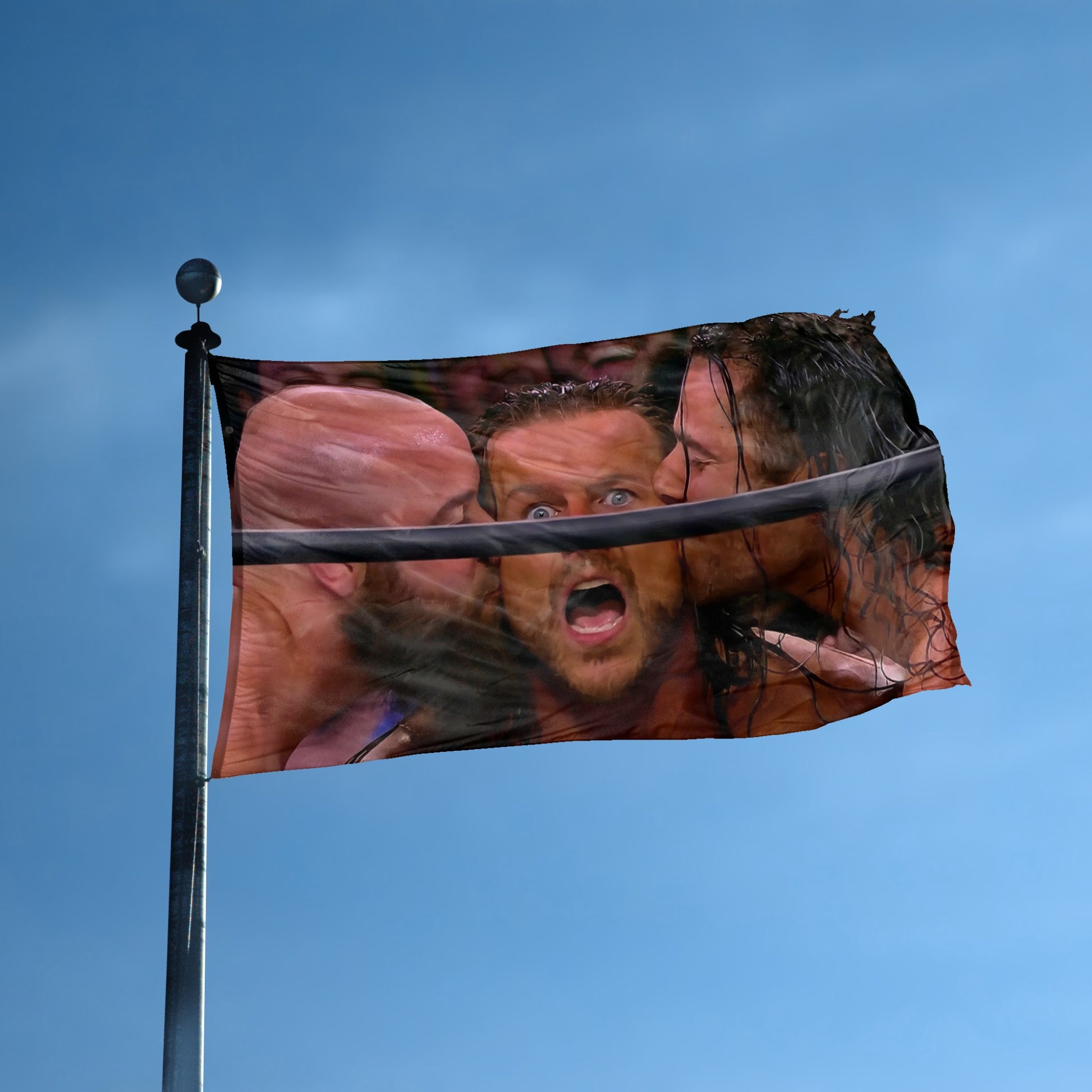 A flag with the theme "Ringside Surprise Kiss Meme" displayed on a tall flag pole and blue skies.