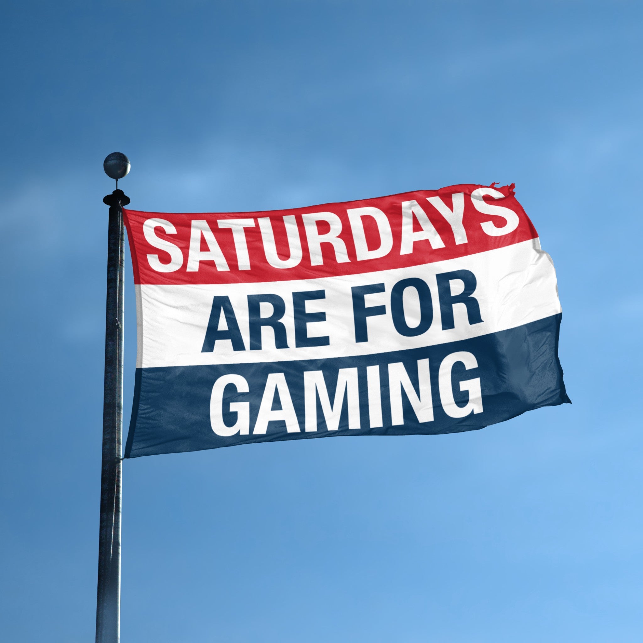 Flag with 'Saturdays are for Gaming' text against a blue sky