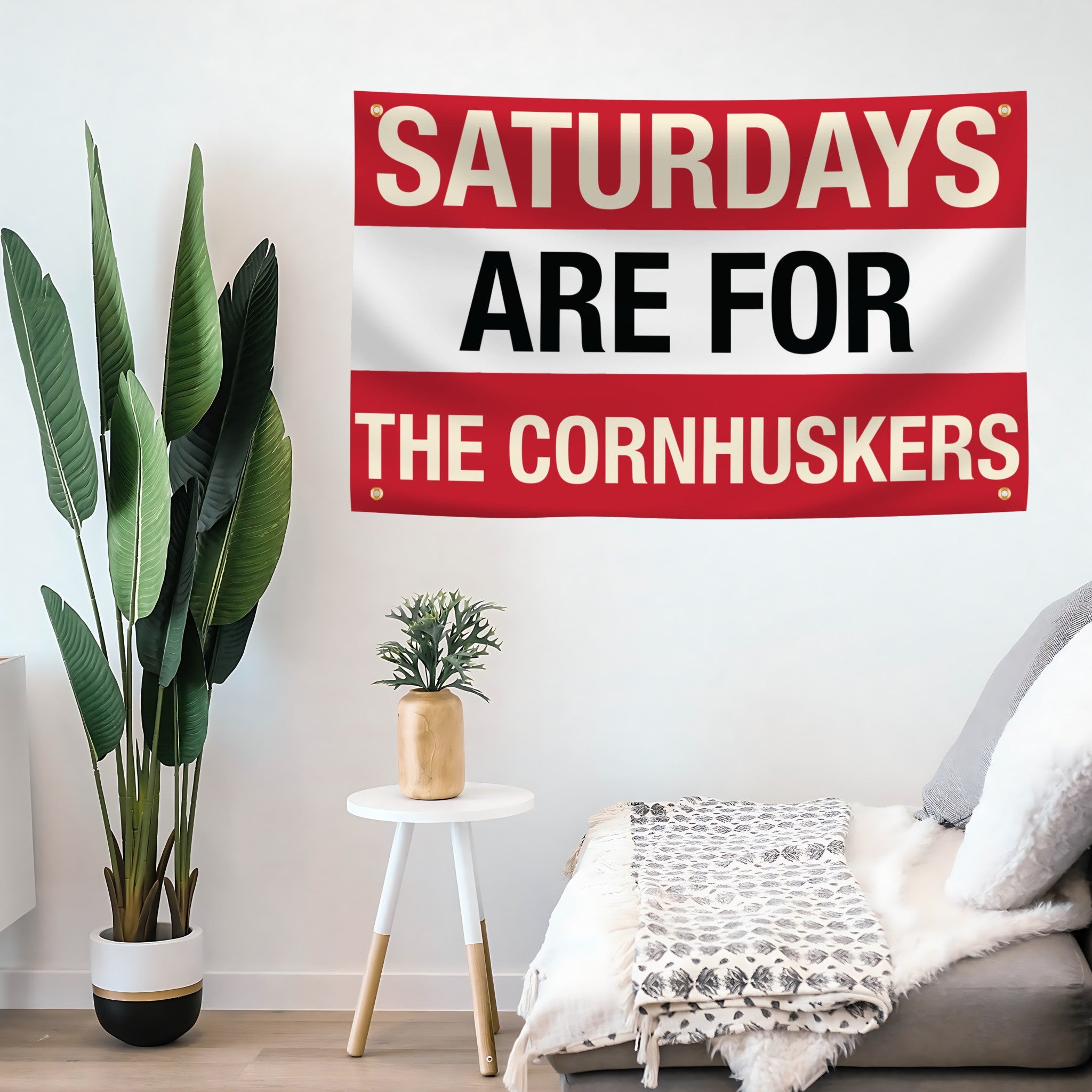 Living room with a decorative flag banner on the wall reading 'Saturdays are for the Cornhuskers'.