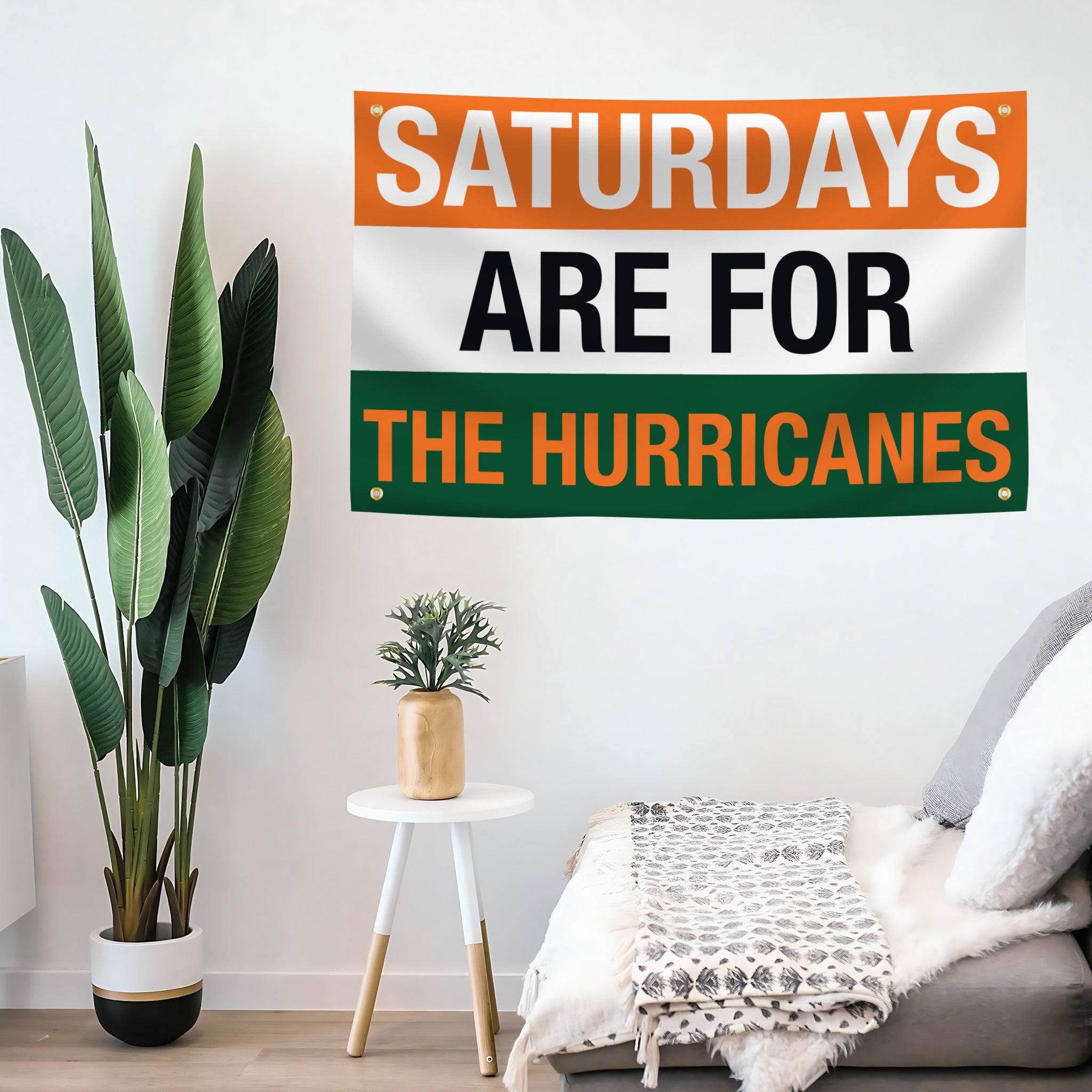 Living room with a decorative flag banner reading 'Saturdays are for the Hurricanes' on a white wall.