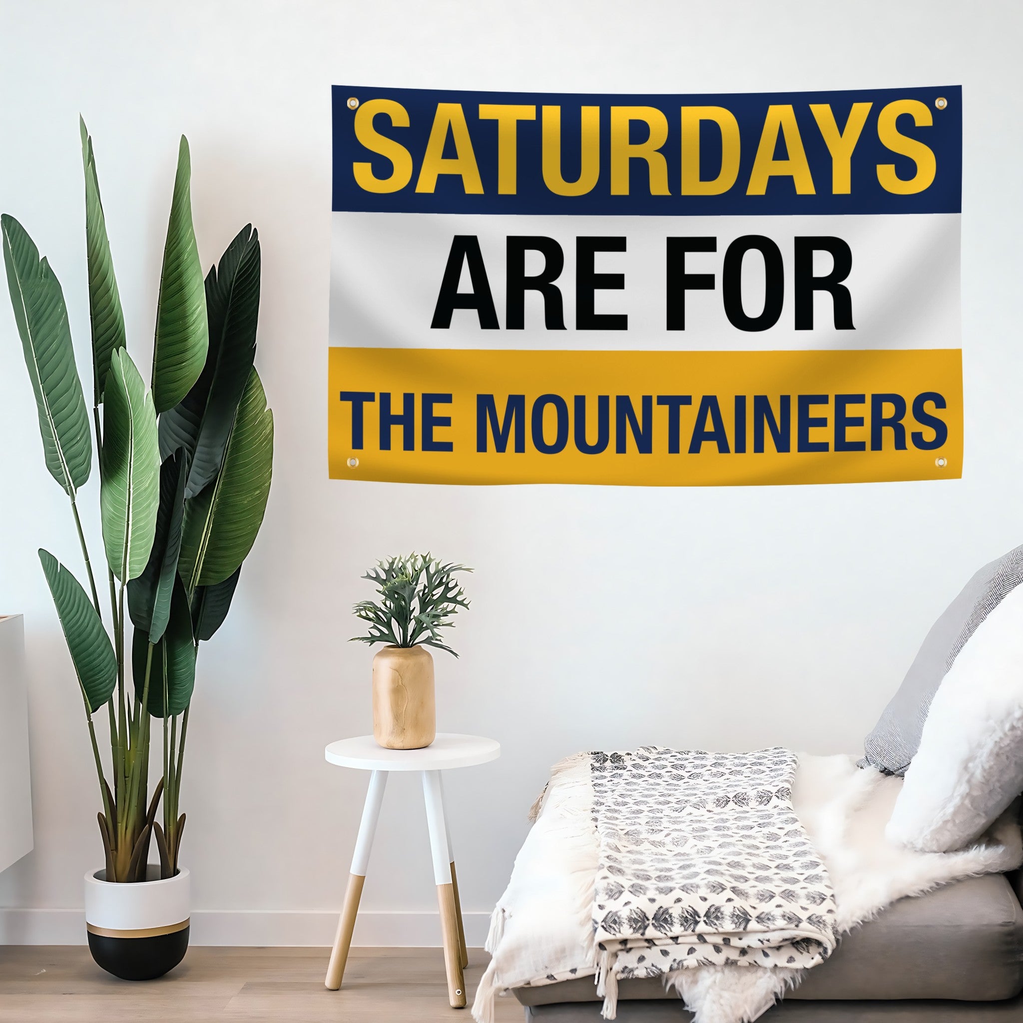 Decorative flag banner with 'Saturdays are for the Mountaineers' text in a living room setting.