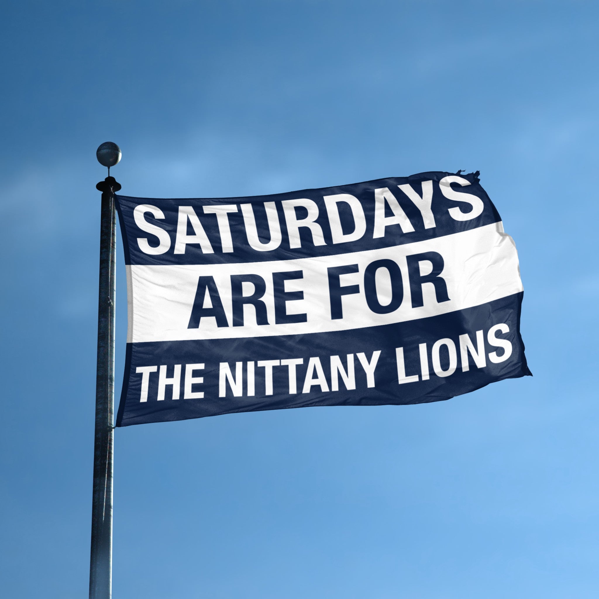 Flag with 'Saturdays are for the Nittany Lions' text on a flagpole against a blue sky