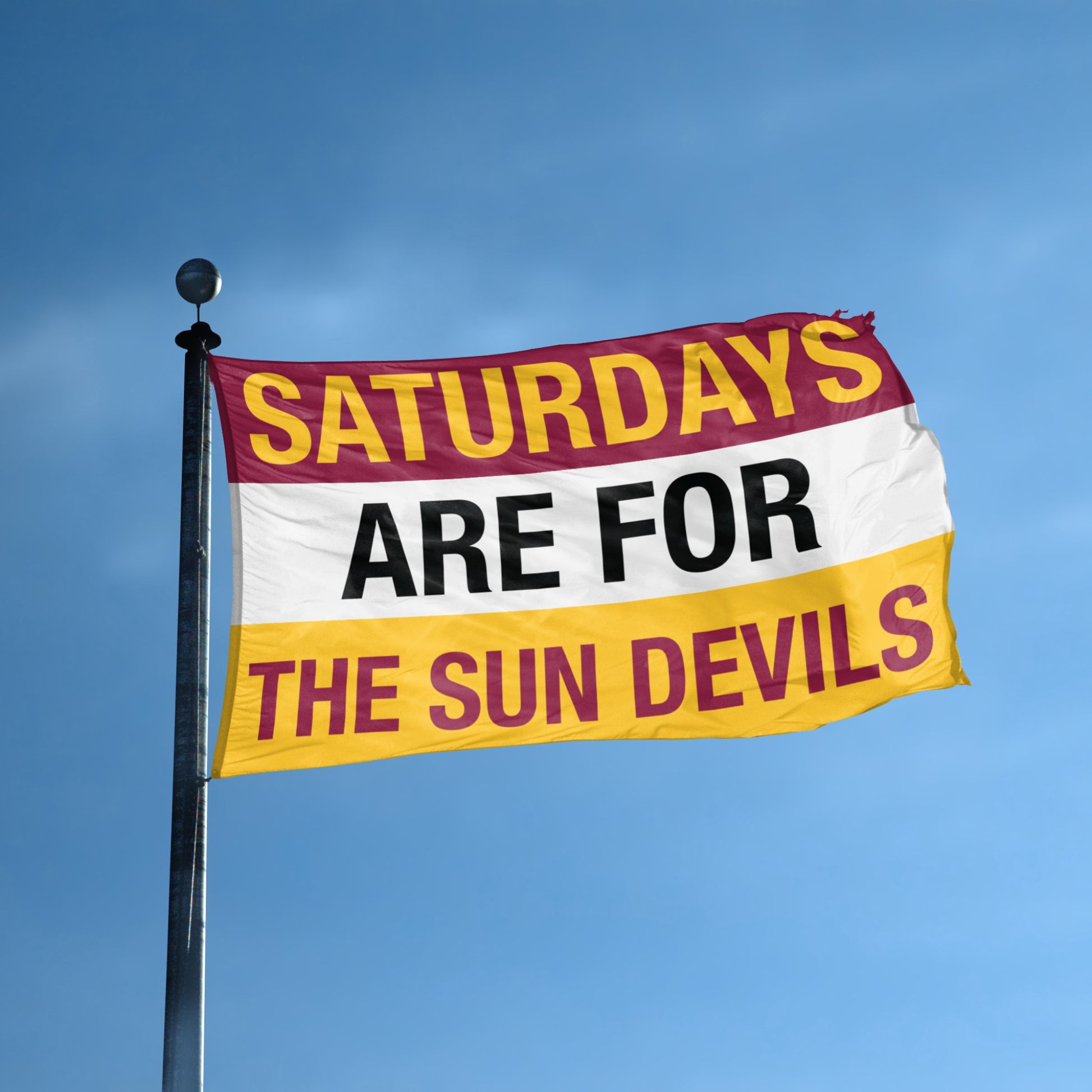 Flag with 'Saturdays are for the Sun Devils' text against a blue sky