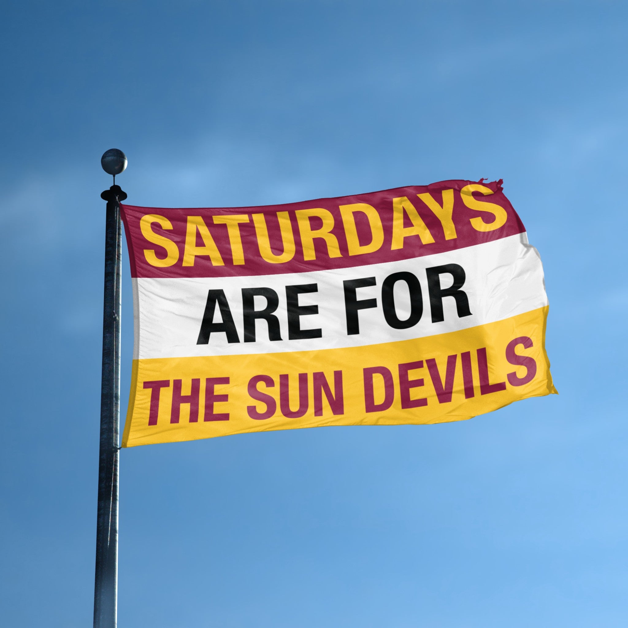 Flag with 'Saturdays are for the Sun Devils' text against a blue sky