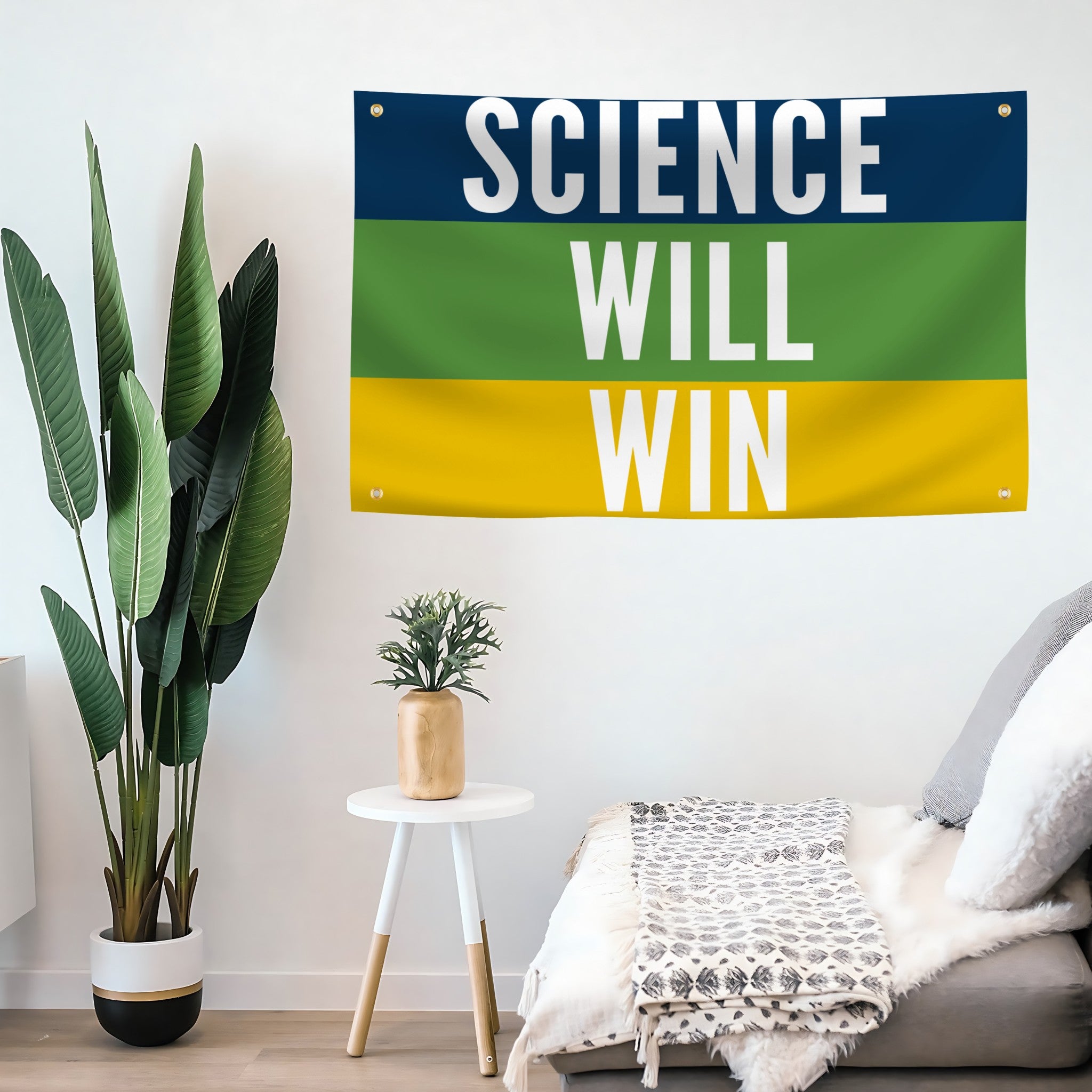 Room interior with 'Science Will Win' banner on the wall, plants, and a sofa.