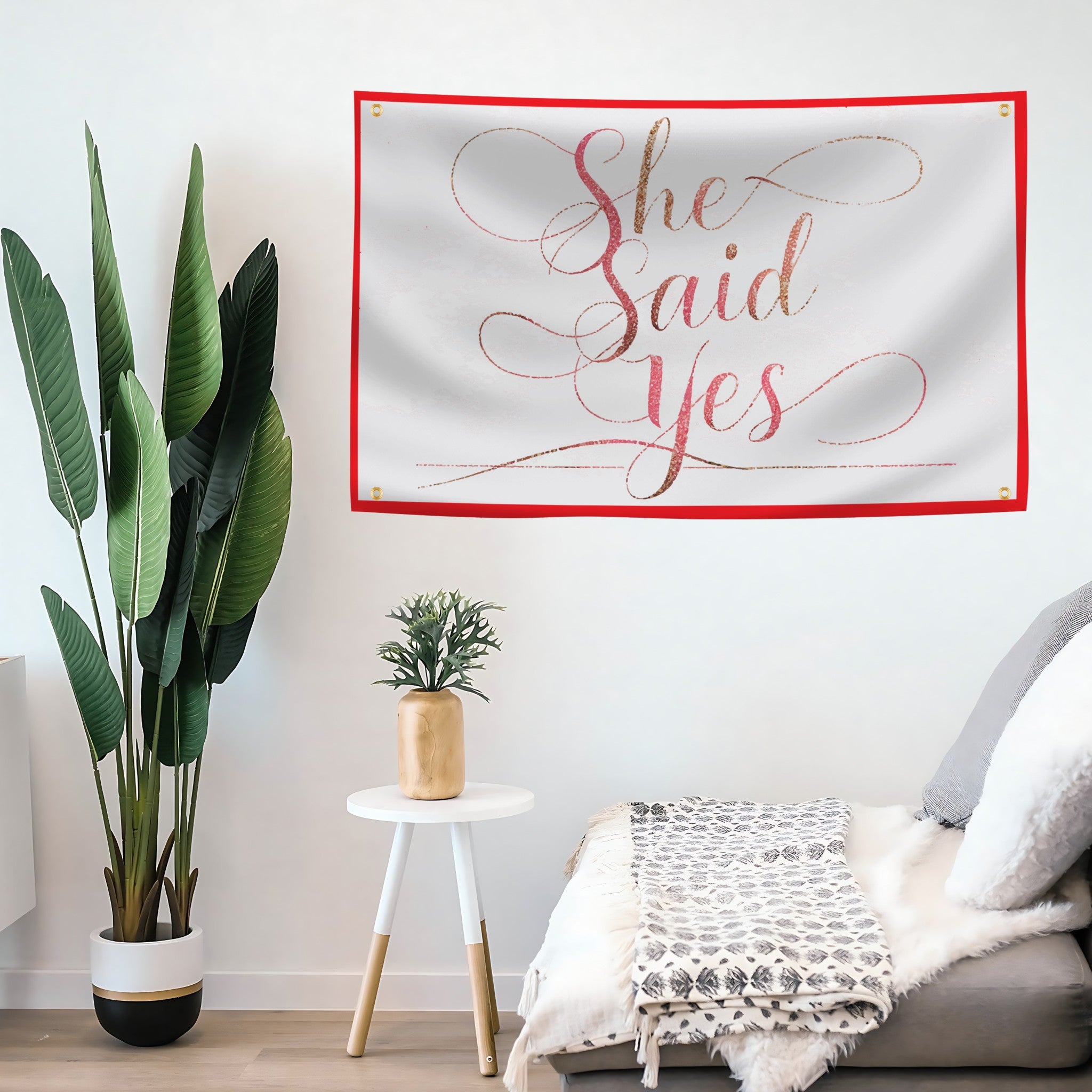 Decorative wall flag banner with 'She Said Yes' in a living room setting.